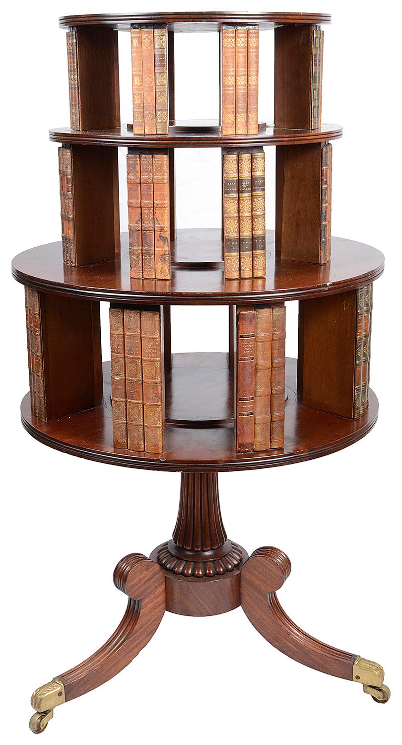 A very good quality Regency period mahogany revolving circular free standing bookcase, having three graduating tiers each with dummy books, raised on a tripod reeded base, terminating in brass castors.

Batch 38 53022 YEAZZ