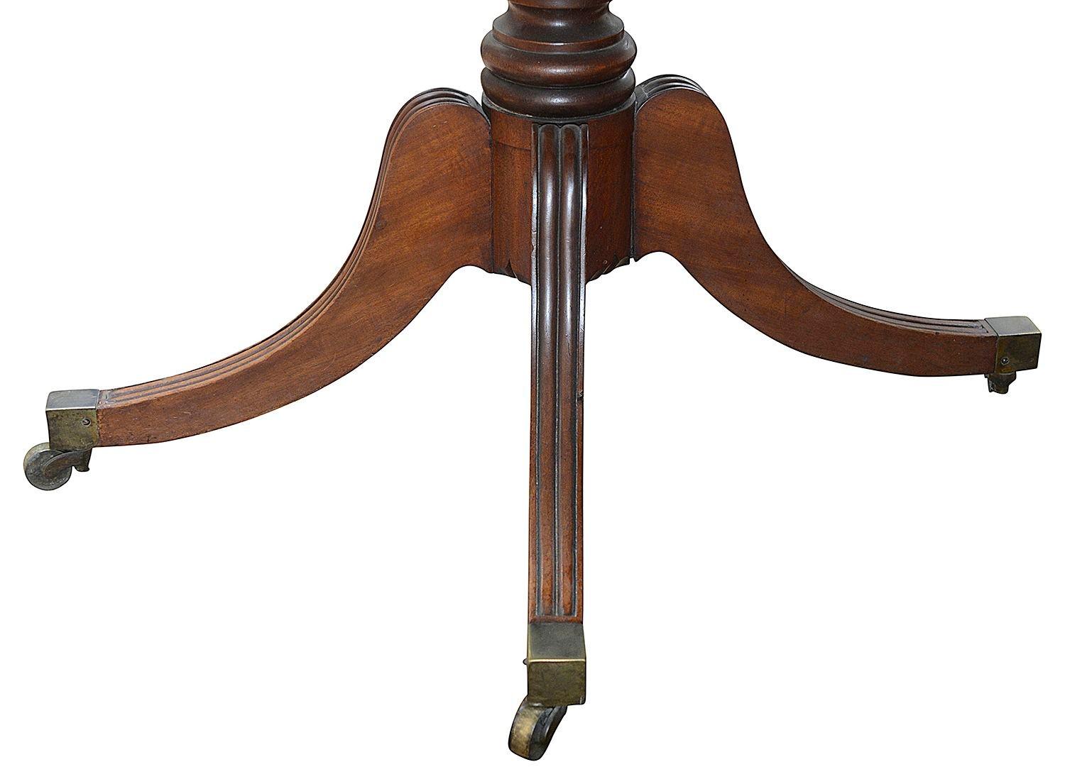 A very good quality late regency period Mahogany twin pedestal dining table, having two extra leaves, making it very versatile in its length. 
The pair of pedestals each with four splays, ring turned and reeded decoration, terminating in the