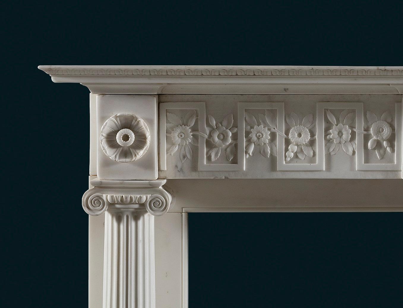 A good quality Regency period, statuary marble column fireplace made in Italy for the English market to a British Neo-Classical design. 
 
The rectangular moulded tiered shelf above the frieze, which is centred with a rectangular plaque with a