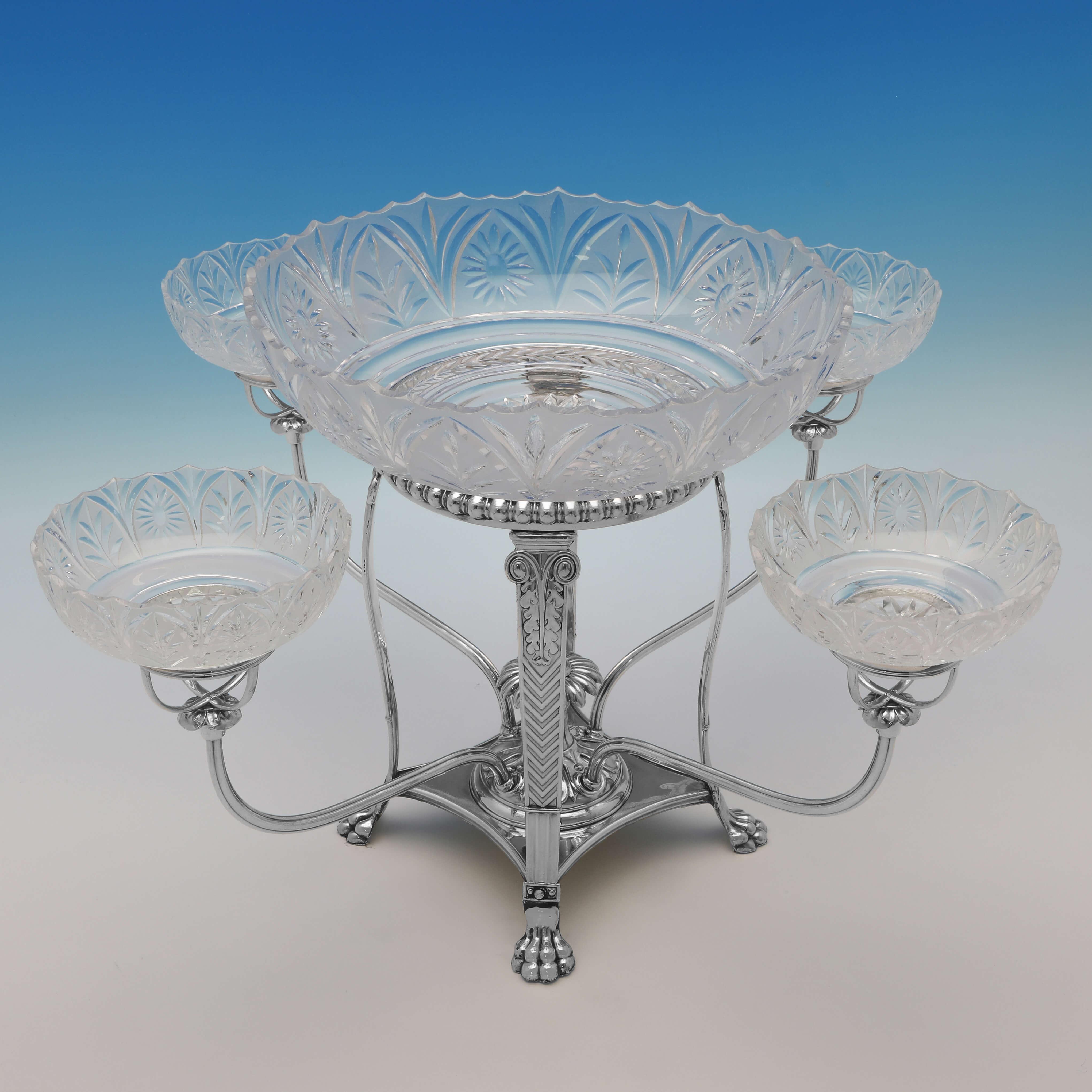 Made circa 1815, this very attractive, Regency Period, Antique Old Sheffield Plate Epergne, features 4 side glass bowls a larger central glass bowl, and an ornate frame. 

The epergne measures 12