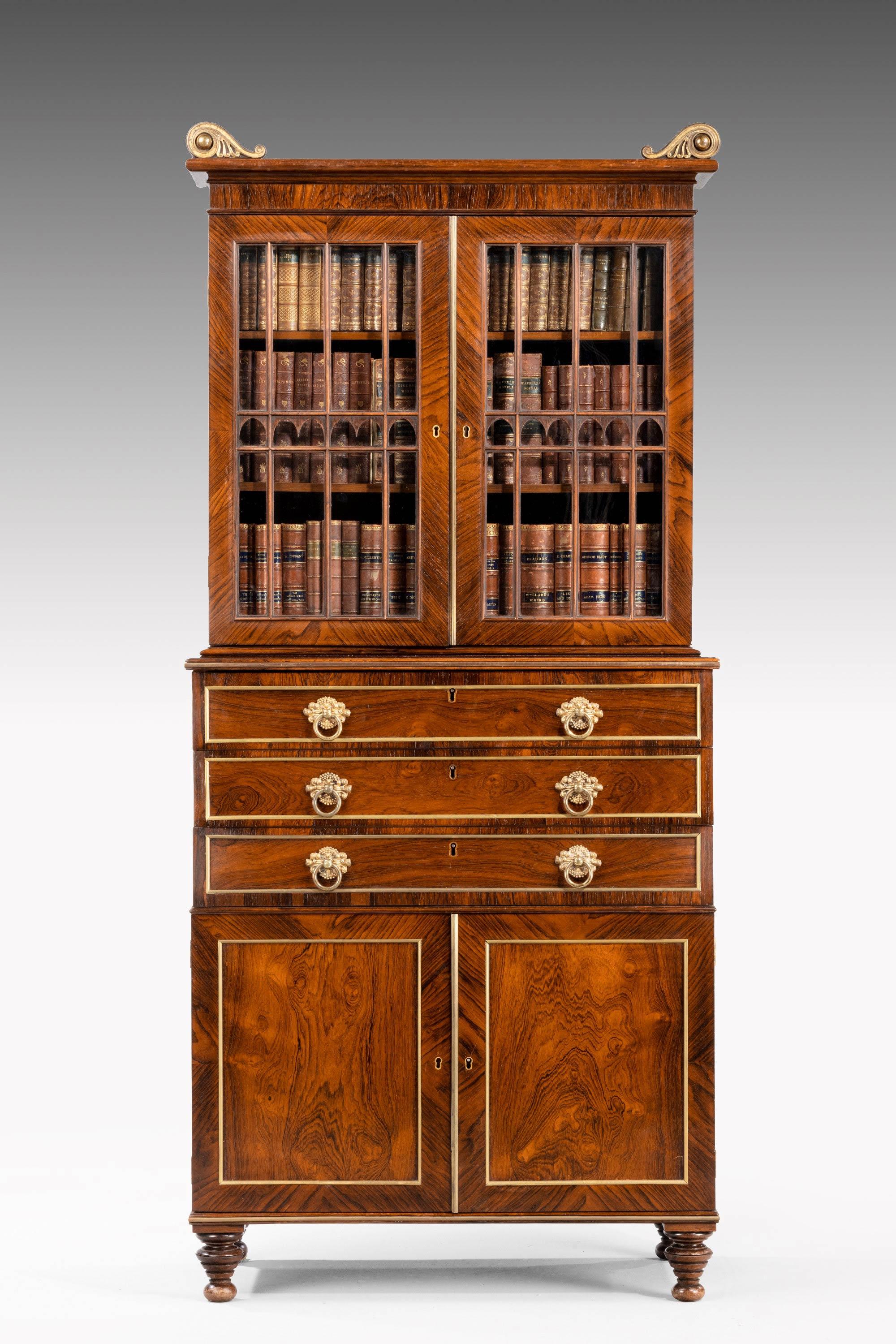 A fine and small Regency period rosewood three-drawer bookcase of wonderful quality. Retaining the original cast scrolled detailing to the pediment. Arched Gothic wooden glazing bars to the top,
circa 1810.