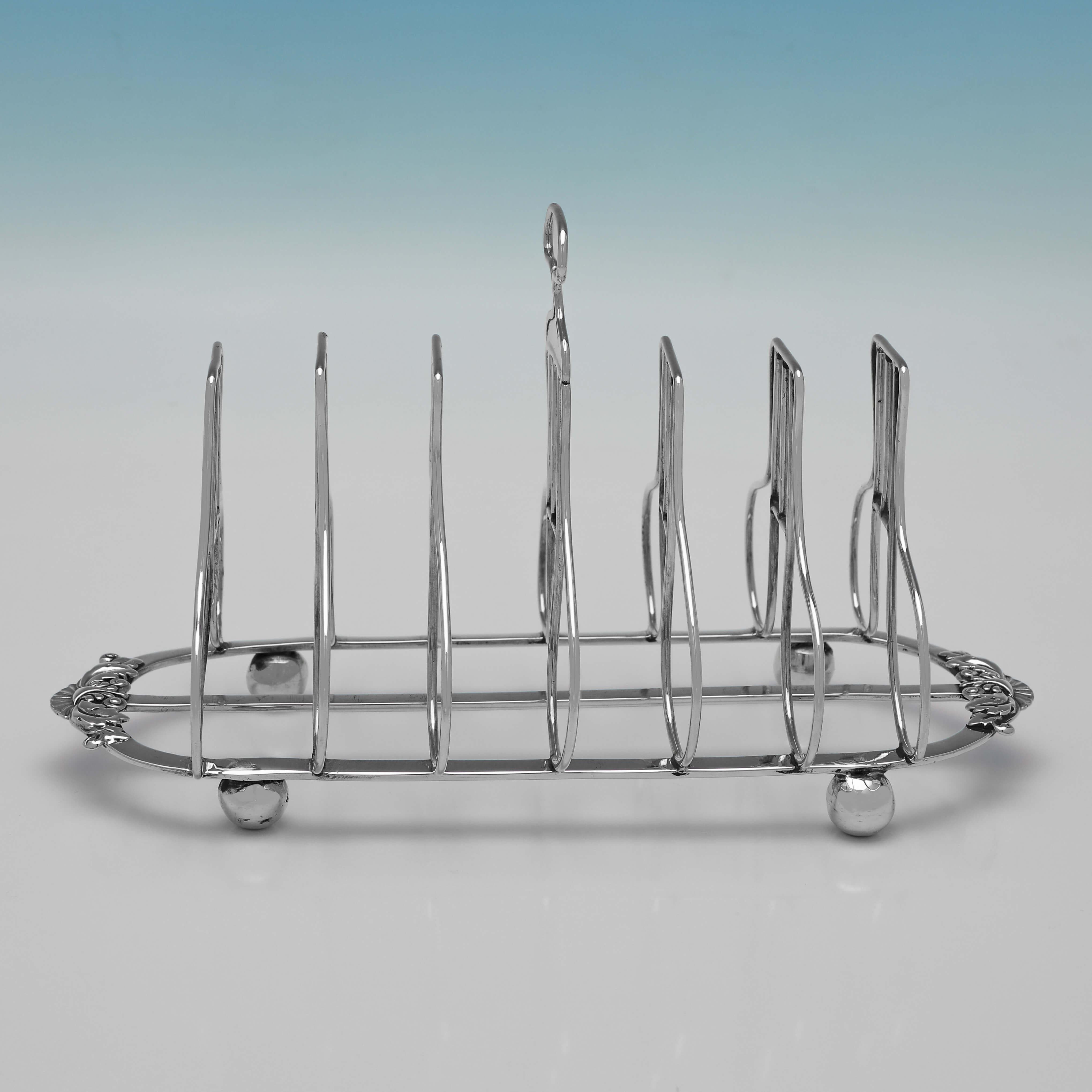 Hallmarked in London in 1815 by Joseph Angell I, this handsome, Regency period, Antique Sterling Silver Toast Rack, stands on 4 ball feet, and will hold 6 pieces of toast. 

The toast rack measures 4.75