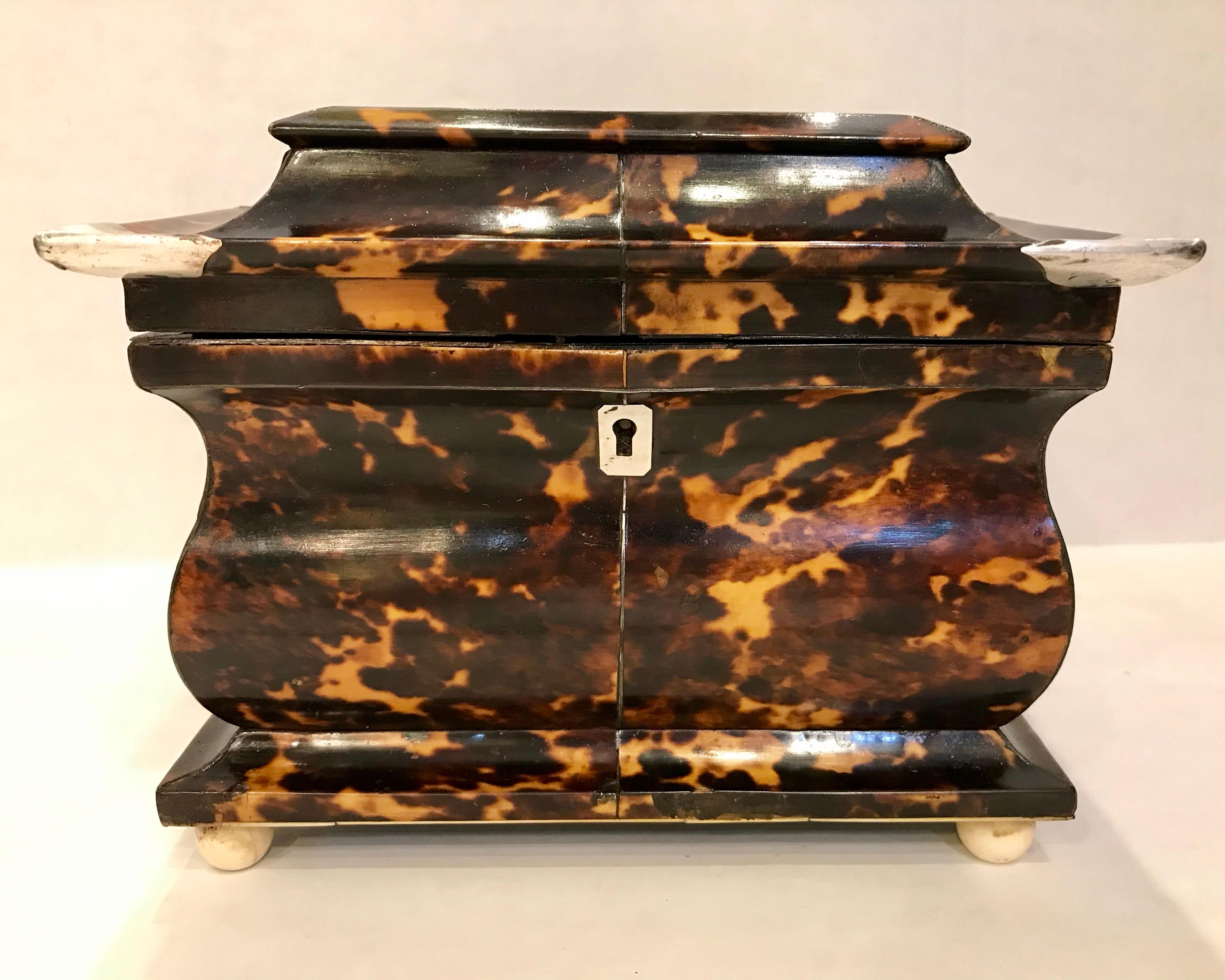 This fine pagoda form tea caddy measures 6” tall, 7.65” long, and 5.1” deep.
The interior lids are original. The corners of the
Top of the caddy are wrapped in what appears to be silver. Desirable pagoda form.