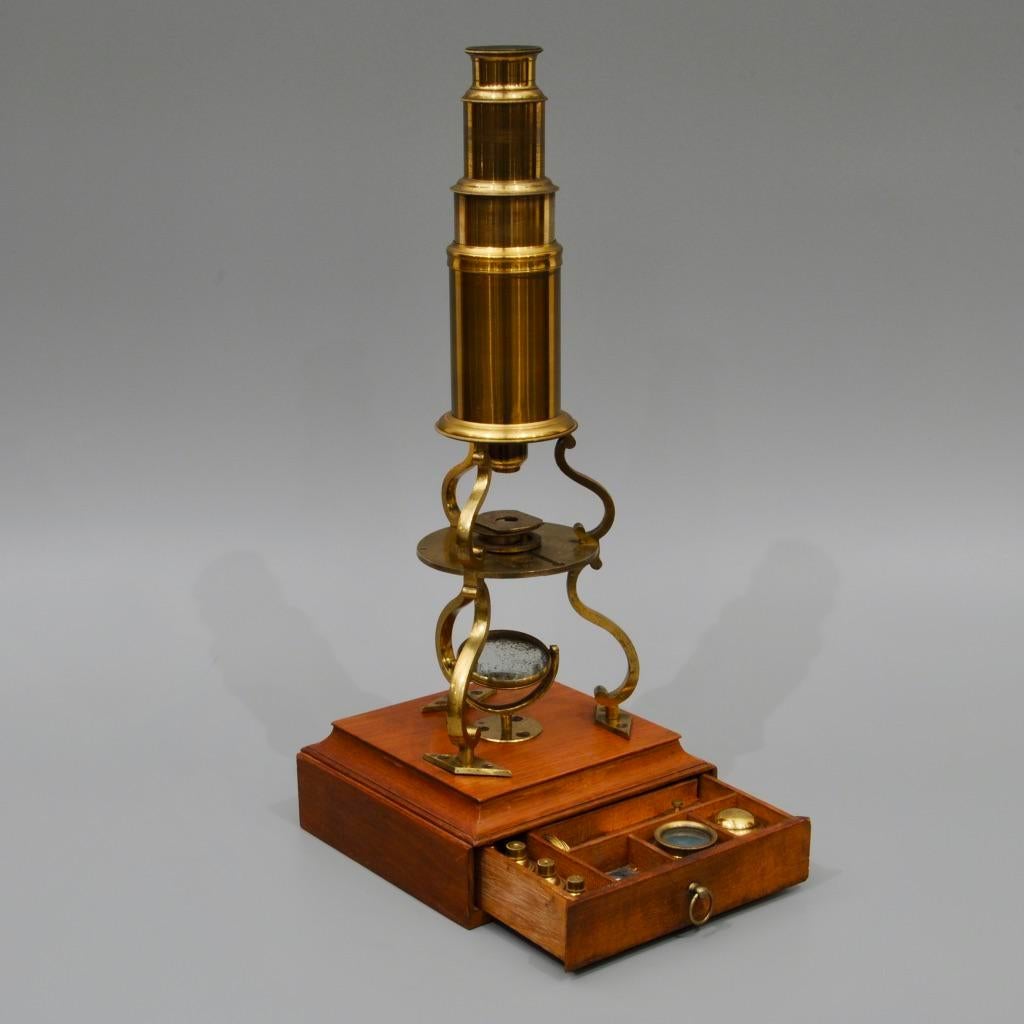 A Regency period brass Culpeper design microscope by William Harris, London. In lovely condition retaining the original lacquer throughout, signed on the stage and the mahogany case with a trade label. The drawer below containing an almost complete
