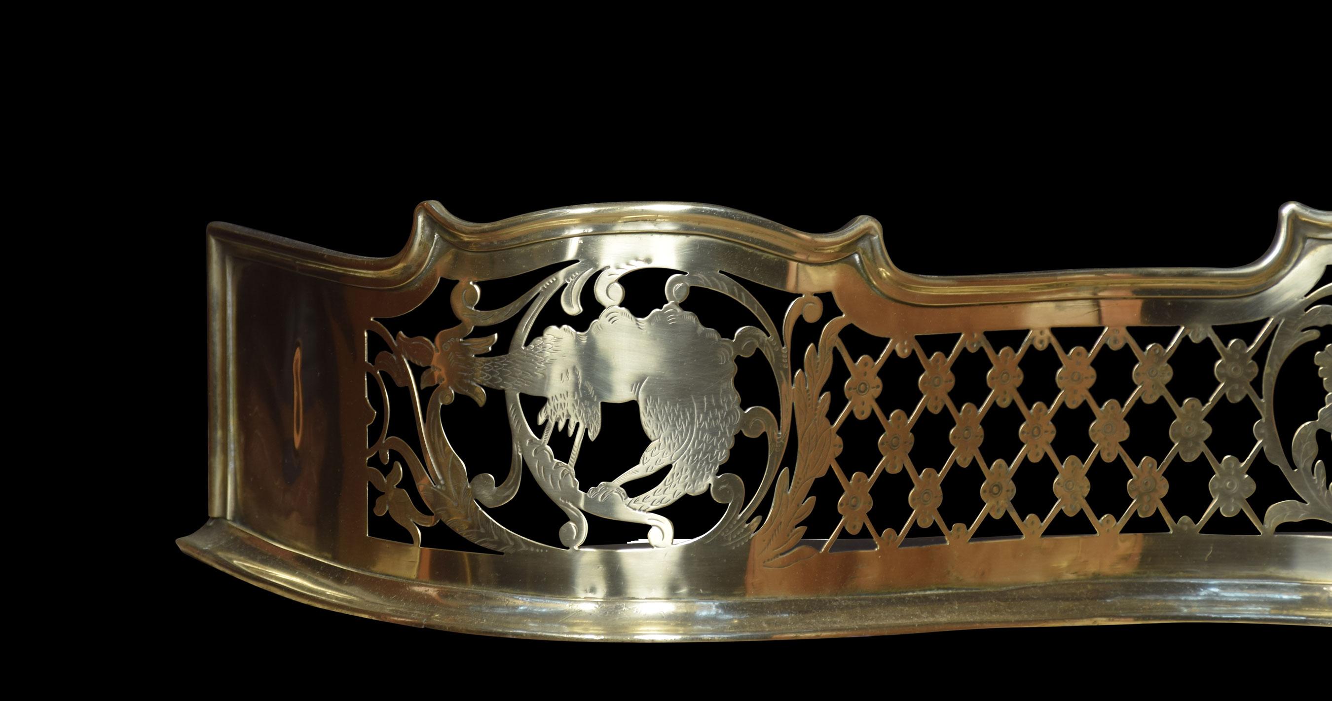 Regency pierced brass serpentine fronted fender, with central urn motif flanked by griffins and phoenix.
Dimensions
Height 8.5 inches
Width 53 inches
Depth 14 inches.