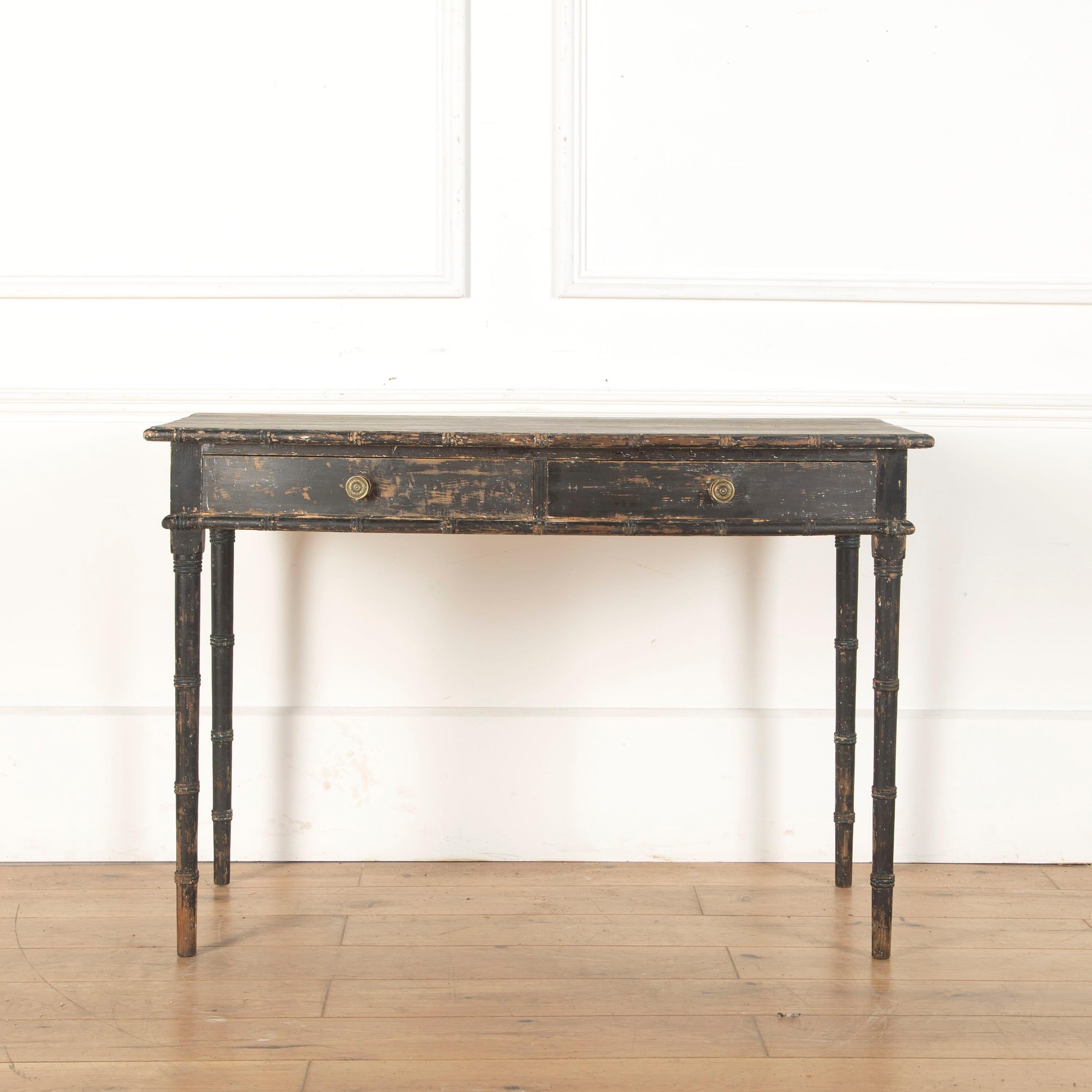 Early 19th century faux bamboo pine table, scraped back to its original black paint. In good condition and retaining its original handles. Circa 1820.