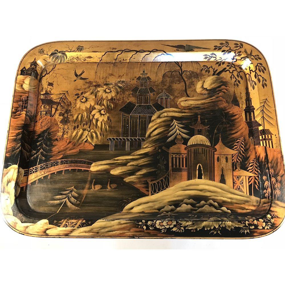 A Regency period polychrome papier-mâché chinoiserie tray on a bespoke ebonised stand. Ca 1810.

In excellent and original condition showing an exotic romantic chinoiserie landscape with pagodas, rockwork, a lake, birds and foliage.

Measures: 
W 67