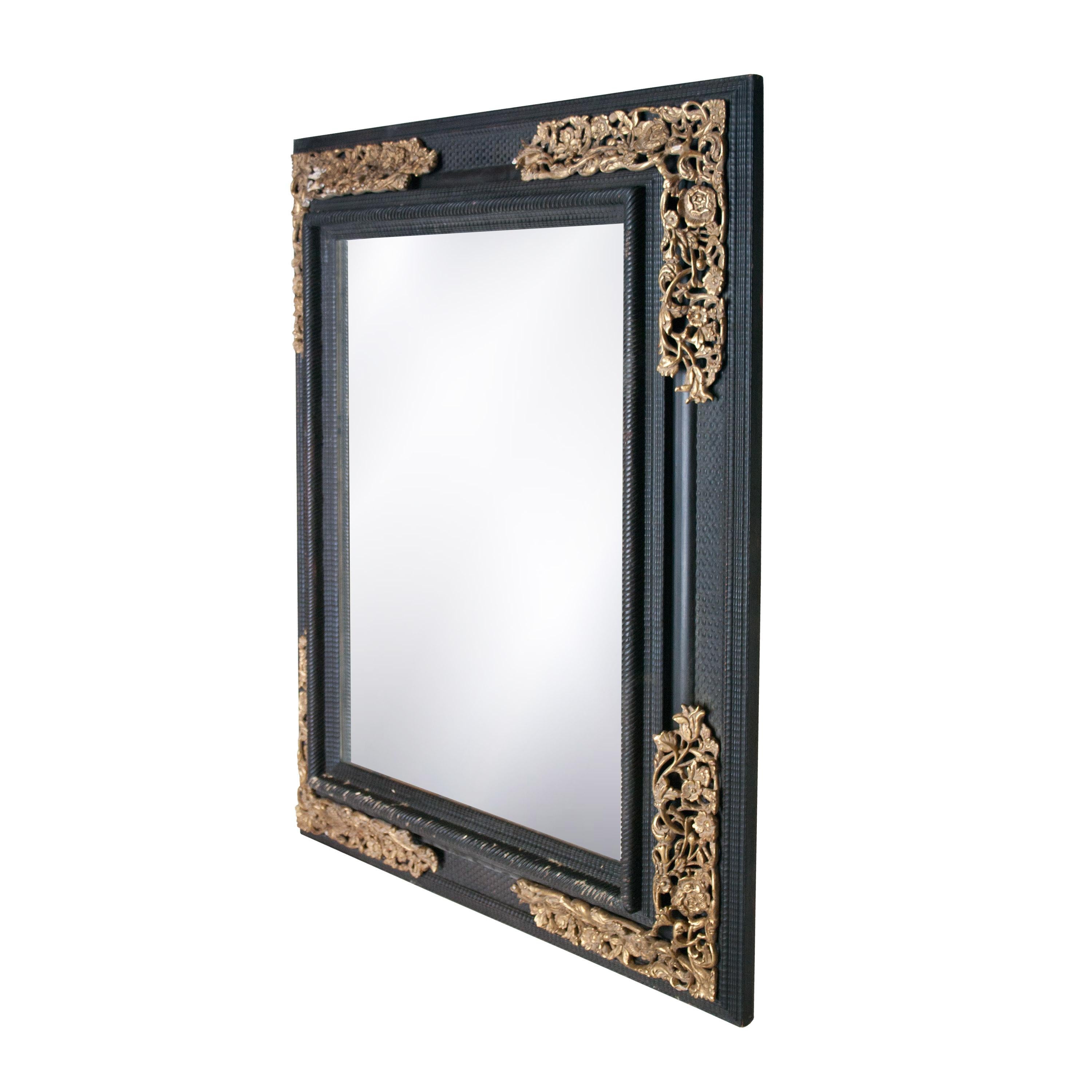 Handcrafted carved Regency style wooden mirror with black finish and gold foiled details.