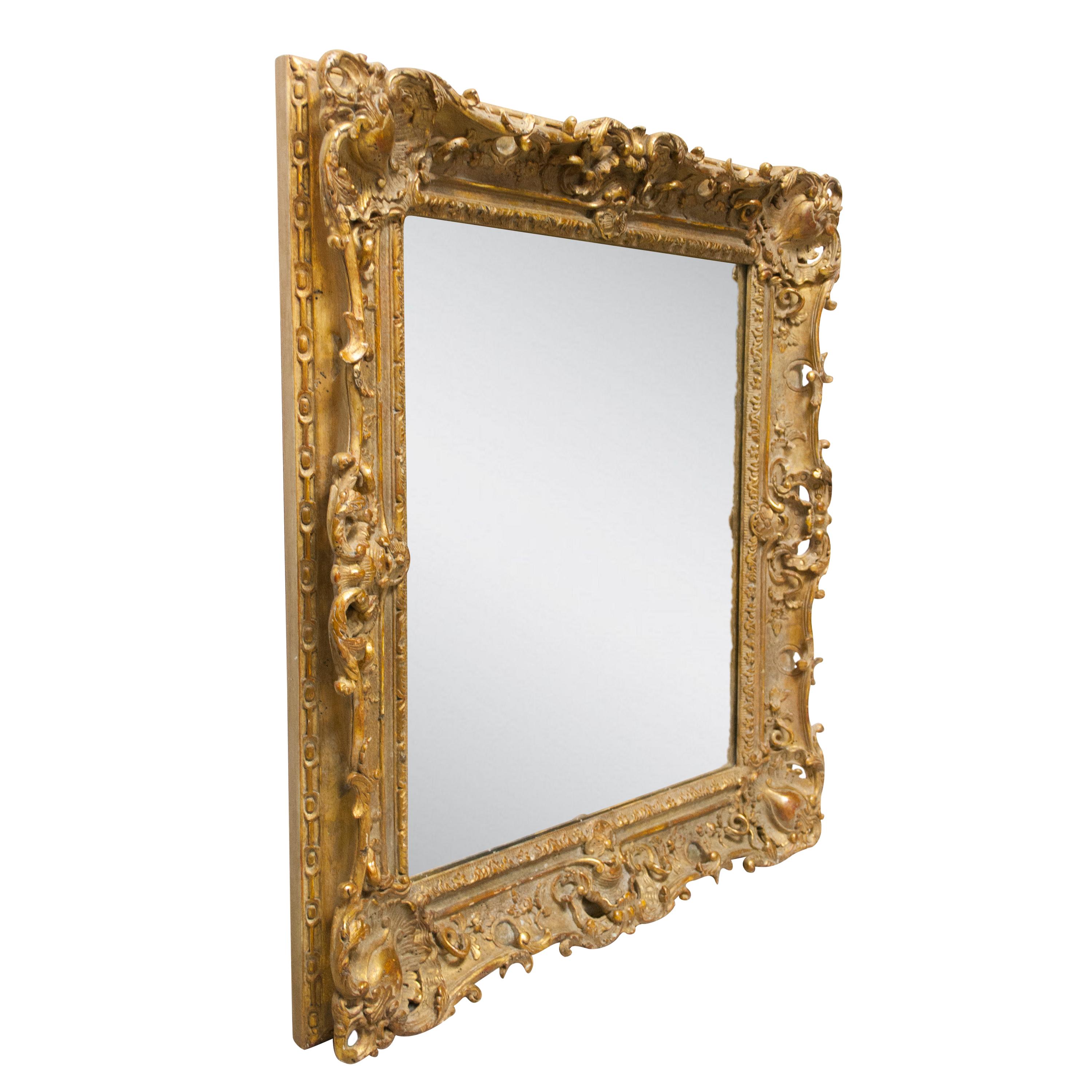 Handcrafted carved Regency Style wood mirror cavered in gold foil.