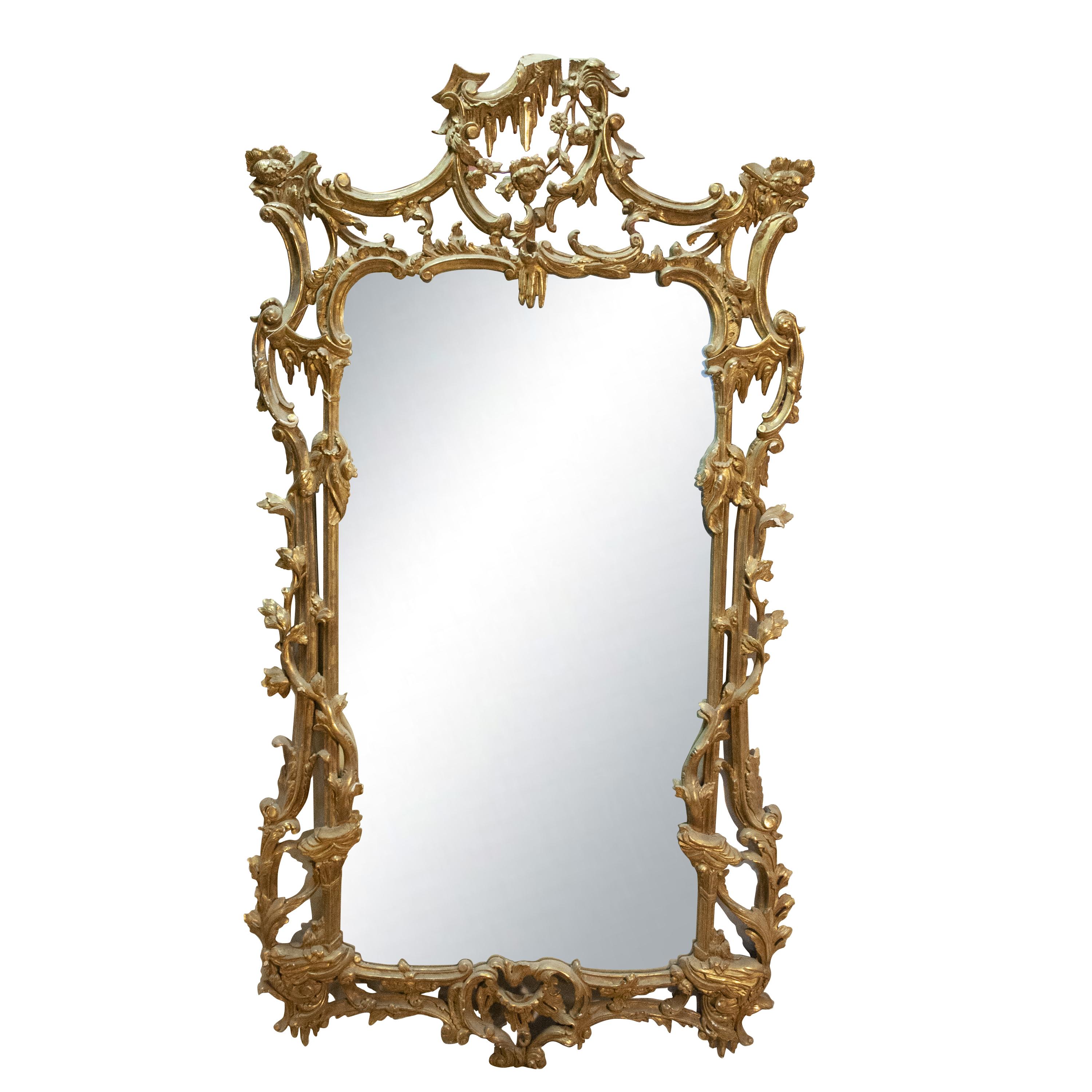 Handcrafted carved Regency Style wood mirror covered in gold foil.