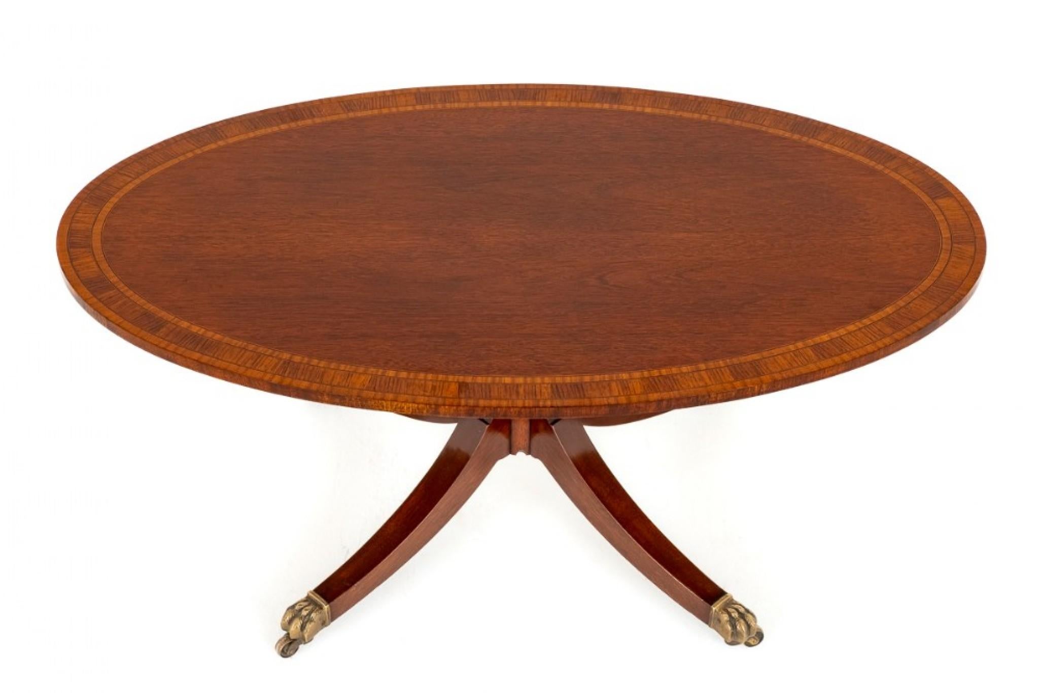 Regency Revival mahogany centre table.
The top of the centre table features triple satinwood cross bandings and highly figured mahogany timbers.
The base having a turned gun barrel column and swept and fluted legs with brass castors.
The table