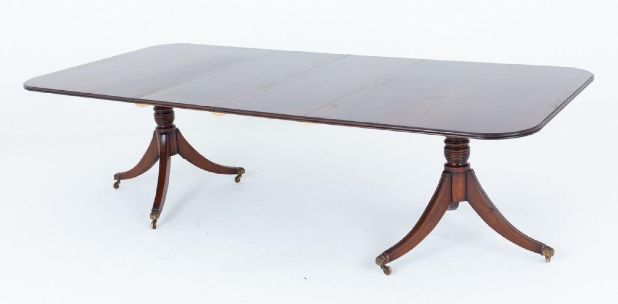 Mahogany regency revival dining table
This dining table stands upon elegant pedestals
Each pedestal having 3 swept legs terminating with brass claw castors Circa 1920
We have various dining chairs to match if you are looking for a
complete dining