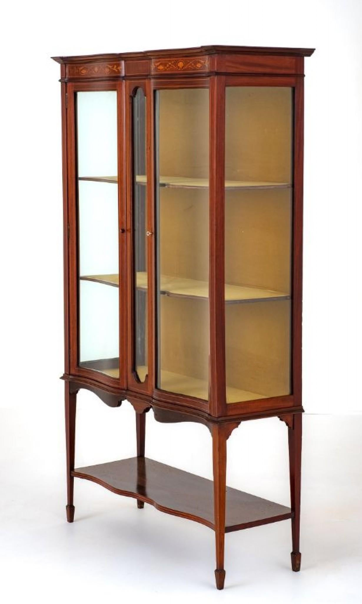 Sheraton Revival Mahogany Inlaid Display Cabinet.
Circa 1890
This Cabinet Stands Upon Square Tapered Legs with Spade feet and Has a Shaped Undertray.
The Cabinet Features 2 Shaped Glazed Doors with a Central Glazed Glass Panel.
The Top Frieze