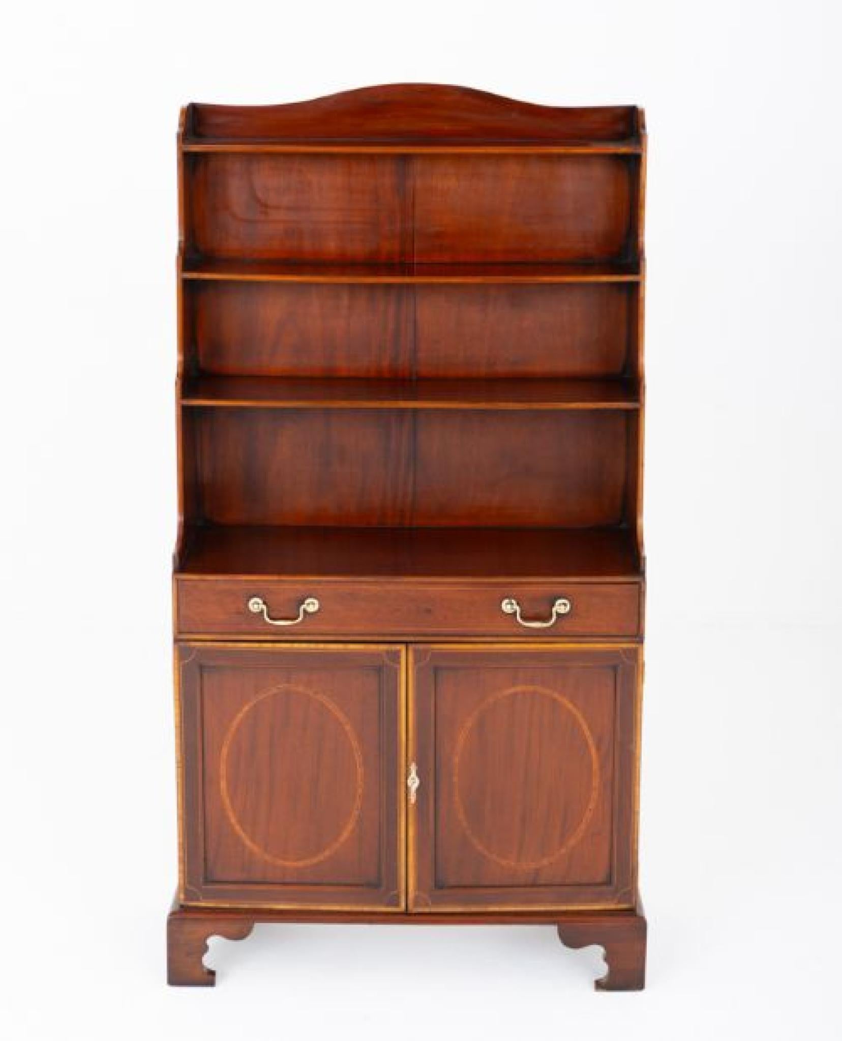 Regency style mahogany waterfall bookcase
The bookcase stands upon bracket feet
Having 2 lower cupboard doors featuring oval inlays, satinwood crossbanding and boxwood line inlays
Circa 1900
The bookcase feature 1 mahogany lined drawer with brass