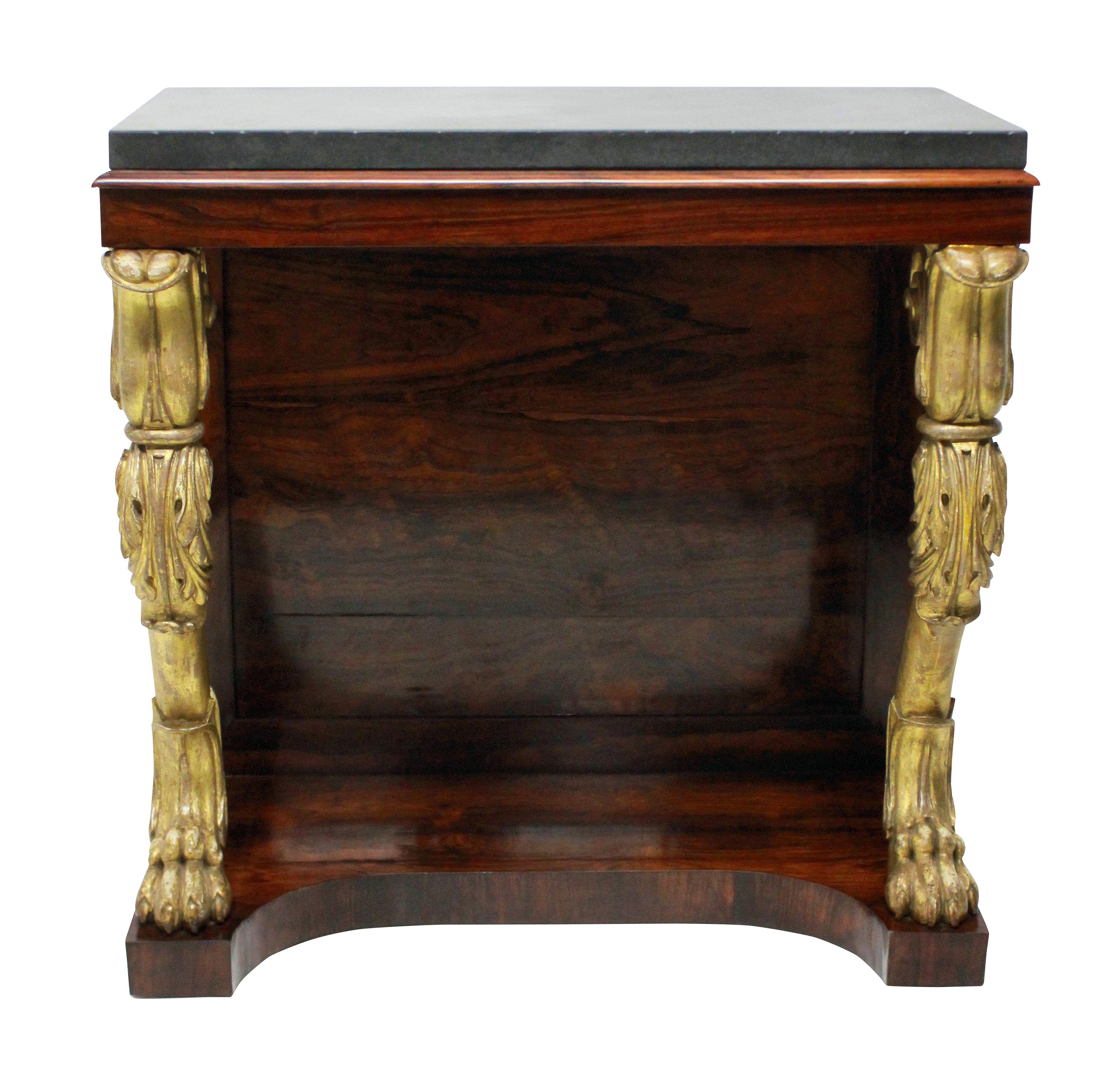 An English Regency console table in rosewood, with two carved and water gilded monopodia legs. The top of Belgian marble.


 