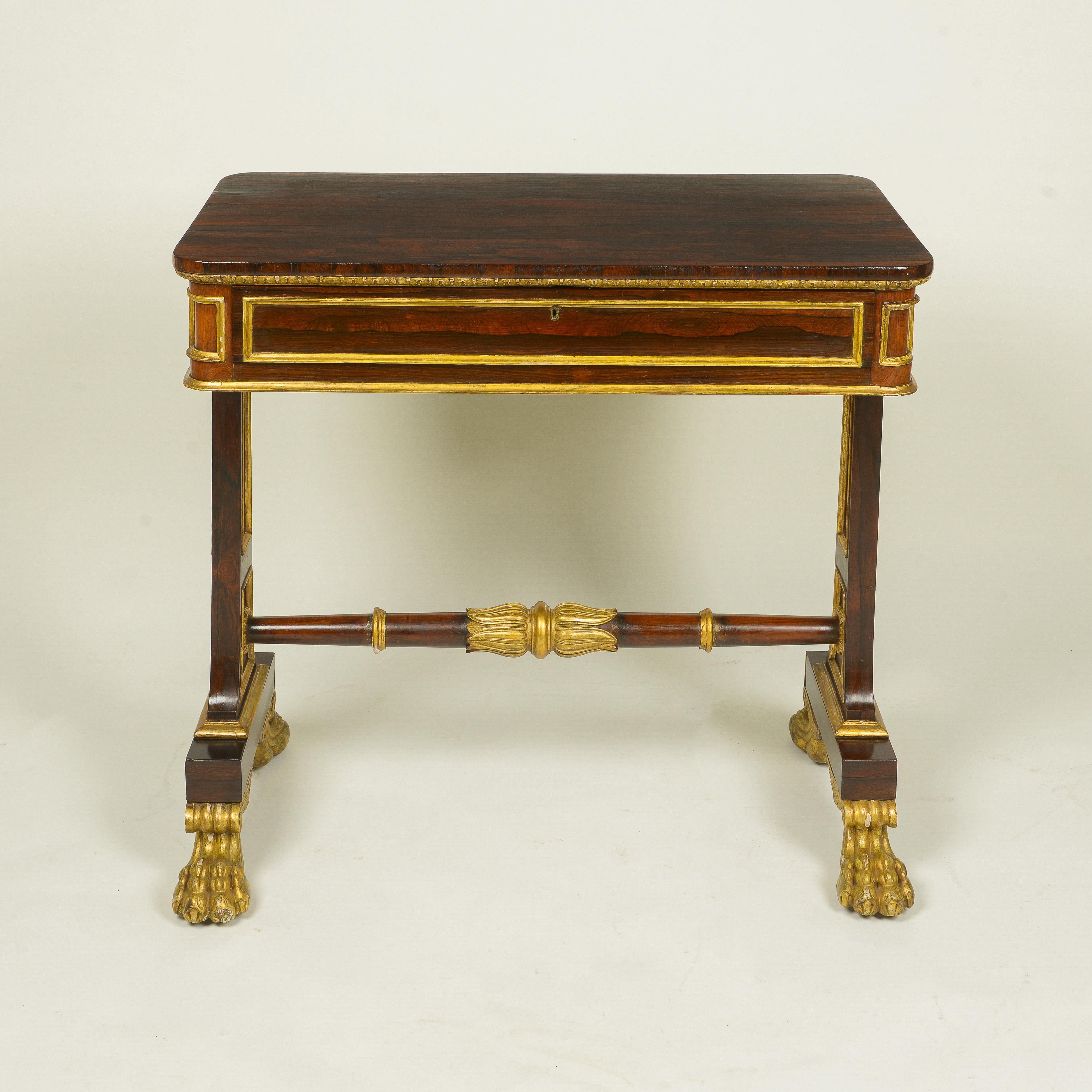 The rectangular top with rounded corners over an ormolu egg-and-dart mounted edge and paneled frieze fitted with one drawer; raised on standard end supports on giltwood winged paw feet and joined by a turned stretcher centered by a lotus leaf clasp.
