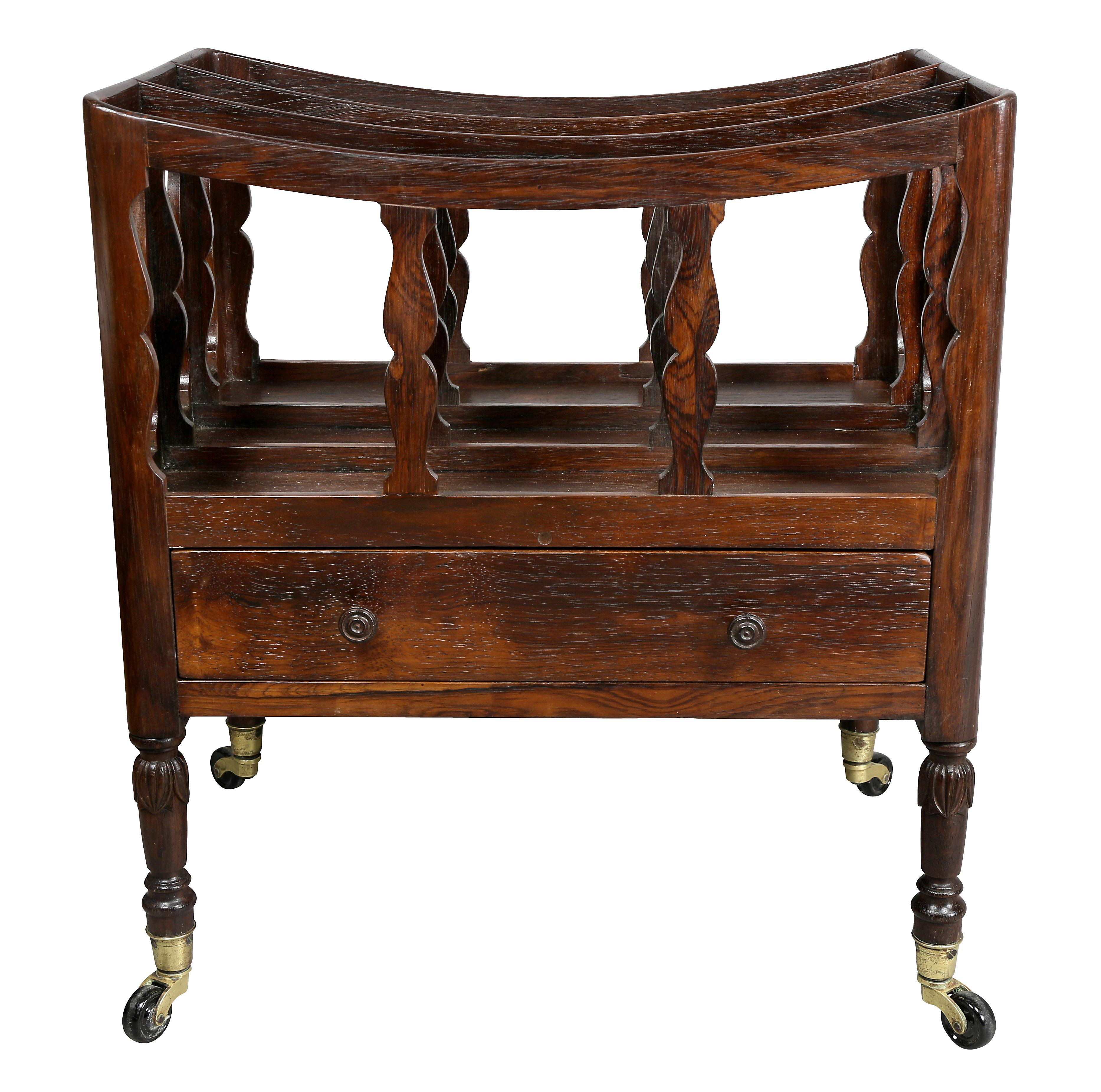 Typical form with rack section above a drawer, raised on turned carved tapered legs, casters.