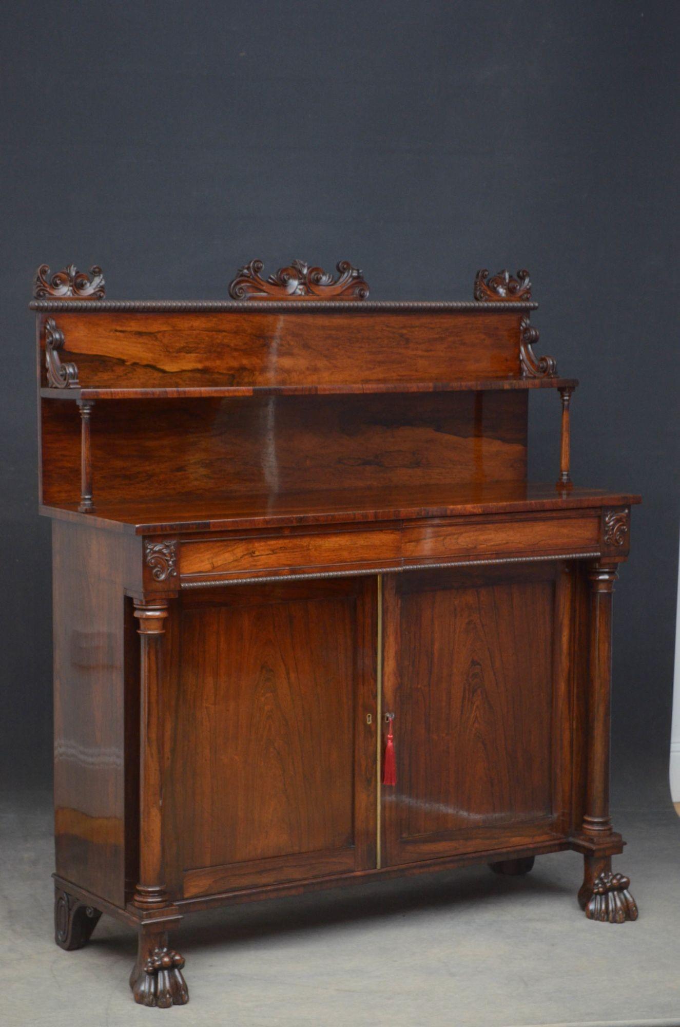 Sn5051, outstanding Regency two door sideboard in rosewood, having a shelf to the back with finely carved decoration to the top and quadrant beaded edge flanked by C shaped carvings, all supported on turned columns above a fantastic grained top, two