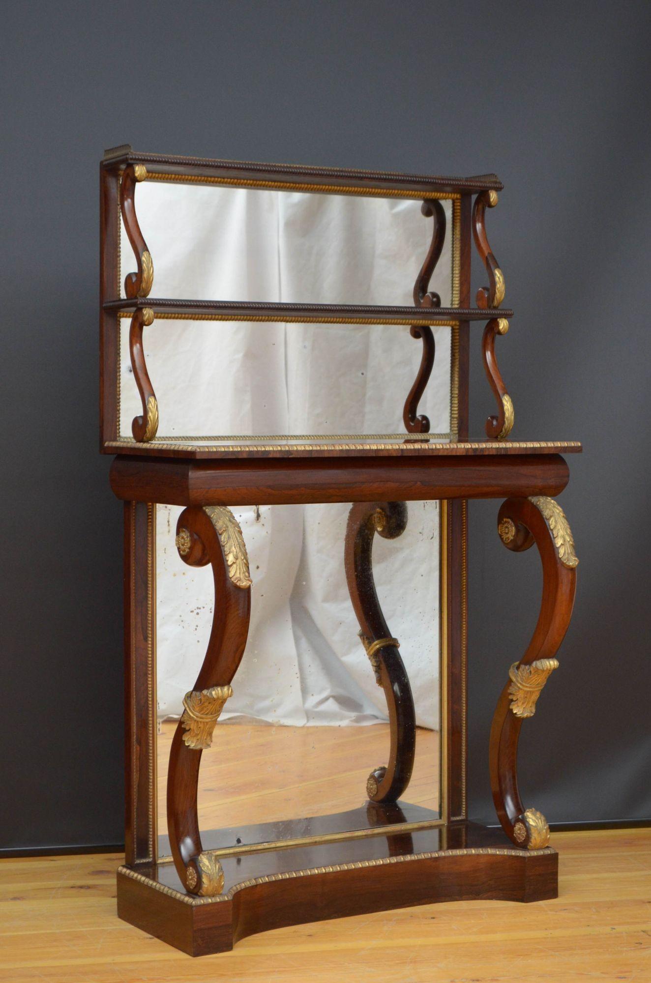 J021 Fine quality and very impressive Regency console table in rosewood, having two tiers with mirrored back raise on S scroll supports and decorated with brass gallery to the top edge, well figured top with brass edge and cylindrical frieze and