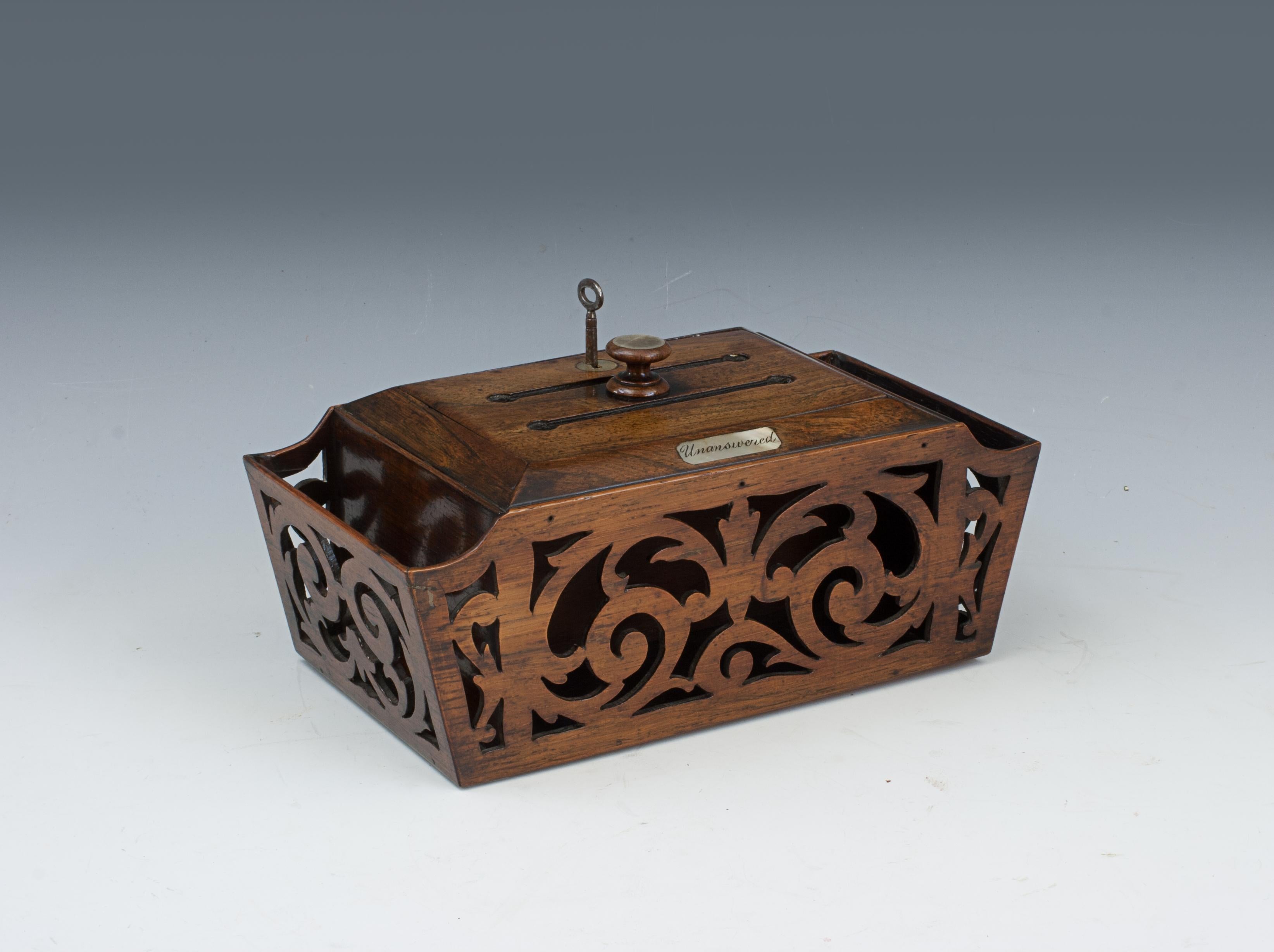 REGENCY LETTER RACK, ANSWERED AND UNANSWERED.
A wonderful letter box, with fretwork design, made from rosewood. There is a central divider within the box to separate the letters. The lid has a turned turned knob in the top of the hinged lid. Next to