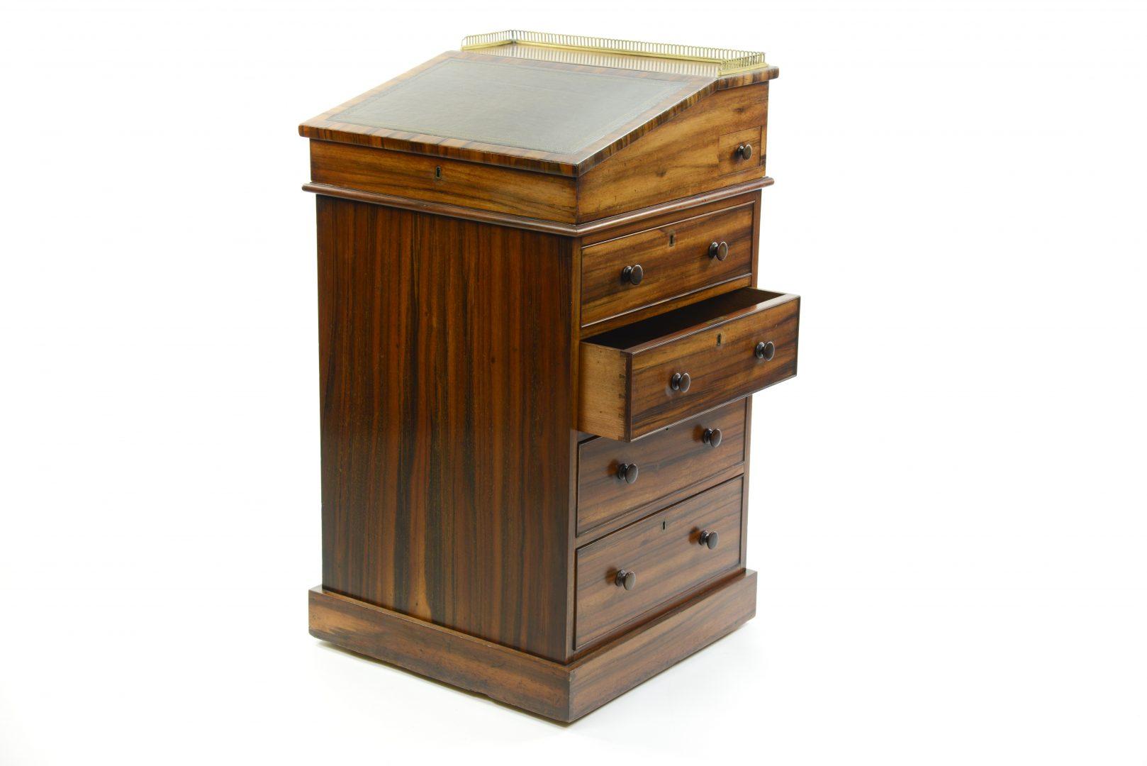 A Regency rosewood davenport by Miles and Edwards, possibly made by Gillows and retailed by Miles and Edwards it carries a signature from Miles and Edwards. During the regency period many of the smaller furniture manufacturers would purchas items