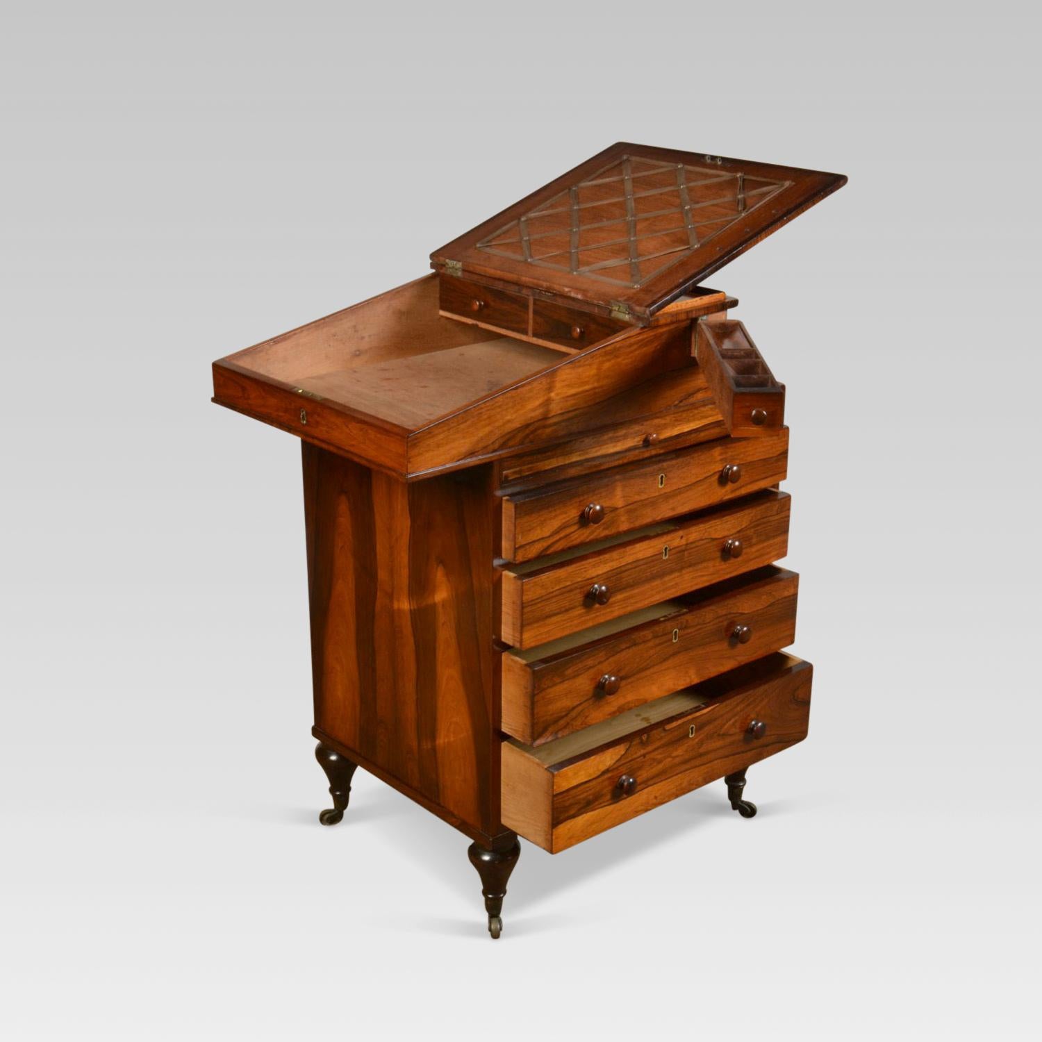 George IV Davenport the top with thin rosewood inset rail, slope fronted burgundy tooled leather lined writing surface, the interior with two small drawers, with 