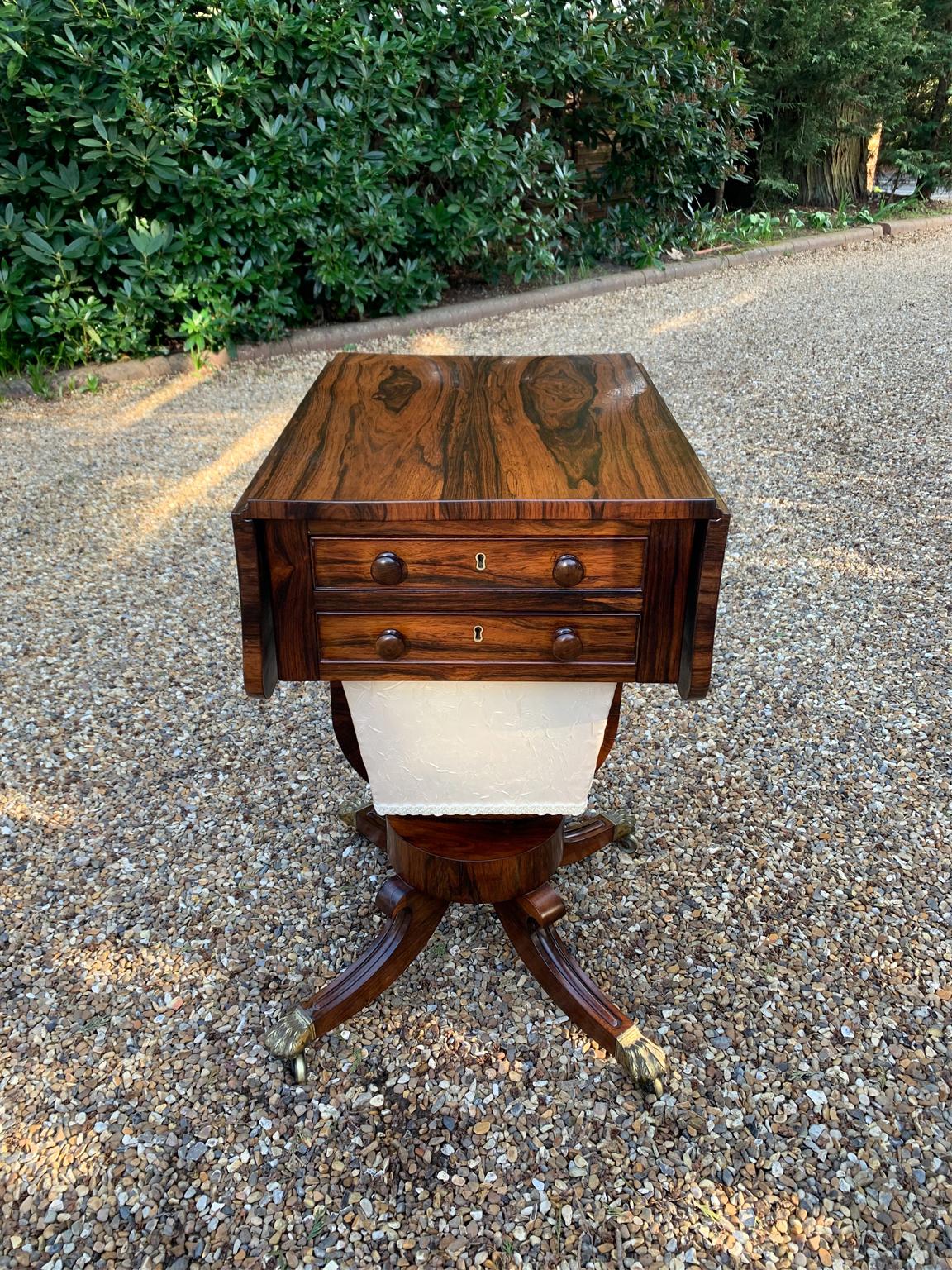 A Regency rosewood drop leaf work table, fitted with a drawer and well, on a platform base.

This lovely small work table is in fine condition and makes an elegant statement whether closed or open. It can be used anywhere in a room with a variety