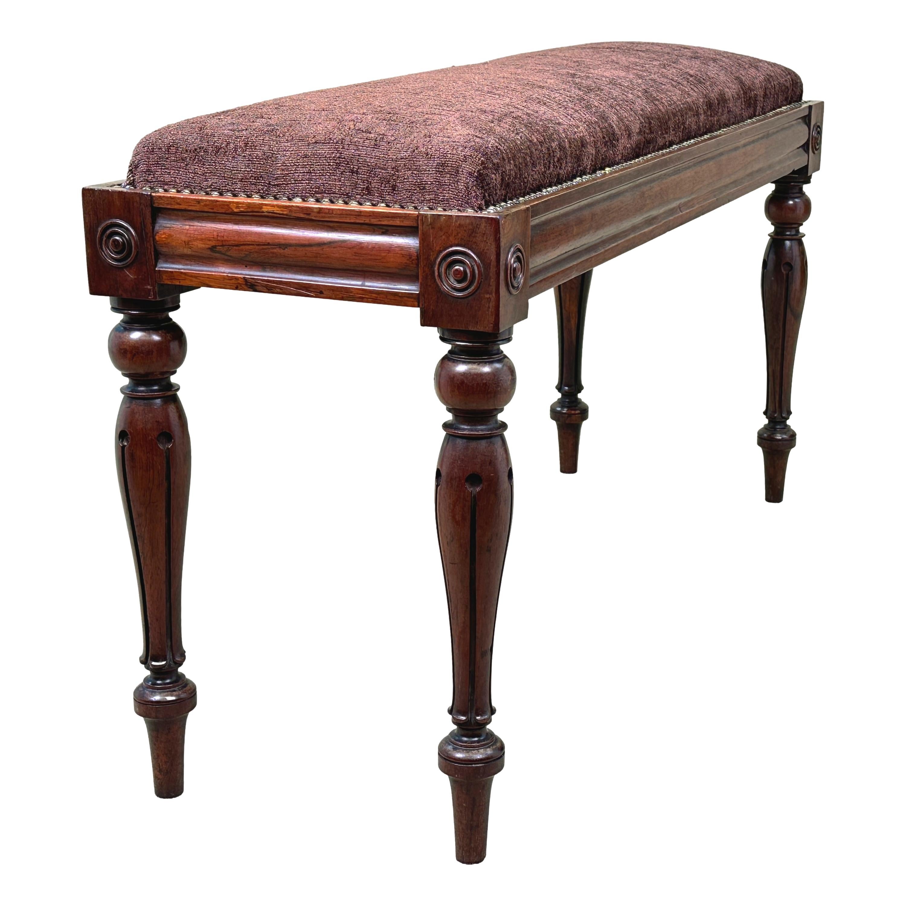 A Very Good Quality Late Regency Period, 19th Century, Rosewood Duet Stool, Or Piano Stool, Having Upholstered Rectangular Seat Over Well Figured Frame With Moulded Channel And Applied Roundel Decoration, Raised On Elegant Bulbous Turned And