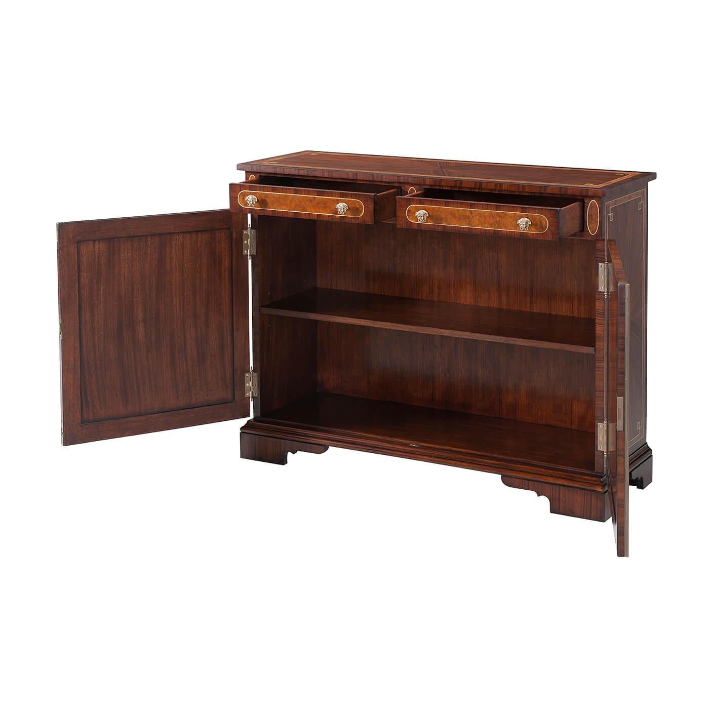 An exceptional Regency style rosewood, inlaid and brass strung side cabinet, the rectangular top above two frieze drawers with ovoid panel inlay, Medusa head brass handles and mounts to the radiating rosewood and banded cupboard doors enclosing an