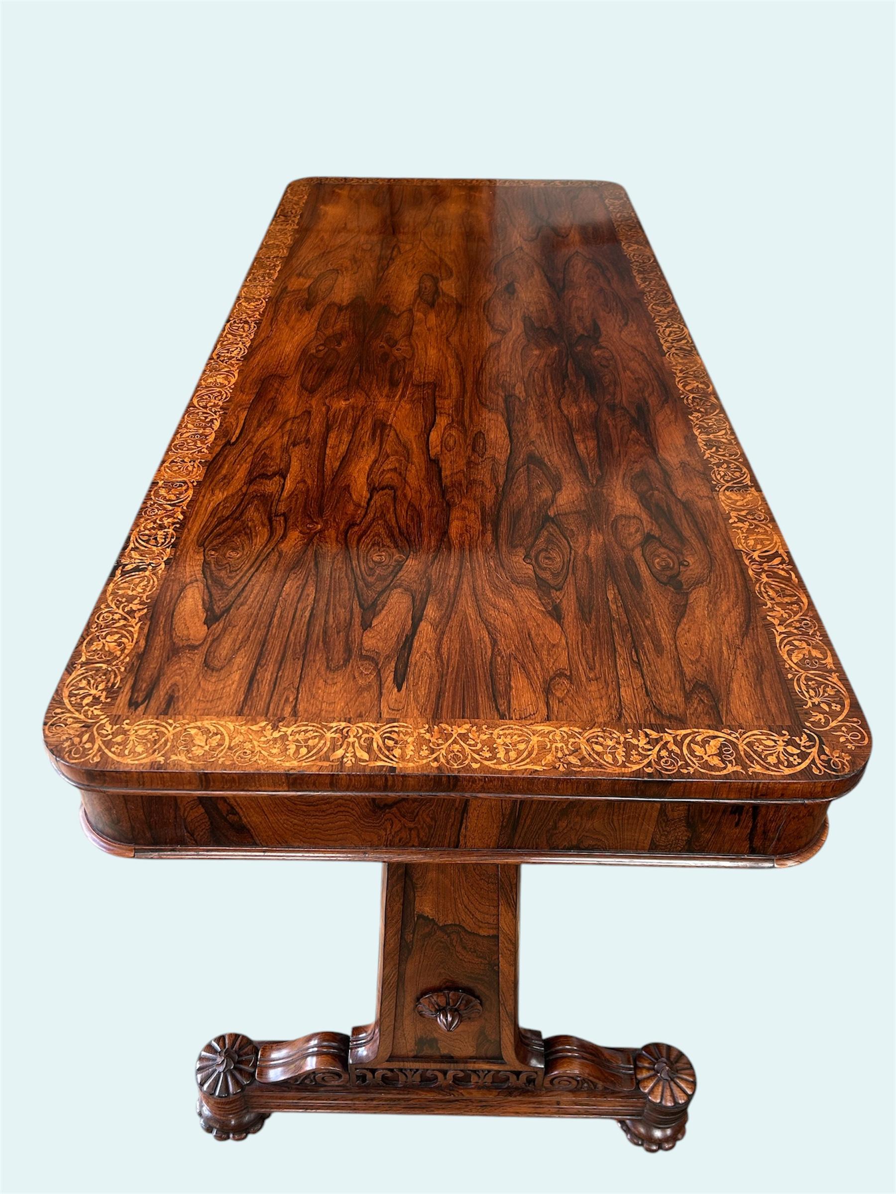 English rosewood library table, attributed to Gillows of Lancaster and London. With elaborate holly wood inlay/marquetry cross banding using Thomas Wilkinson’s tracings who was a draughtsman in the 19th century, both George Bullock and Gillows used