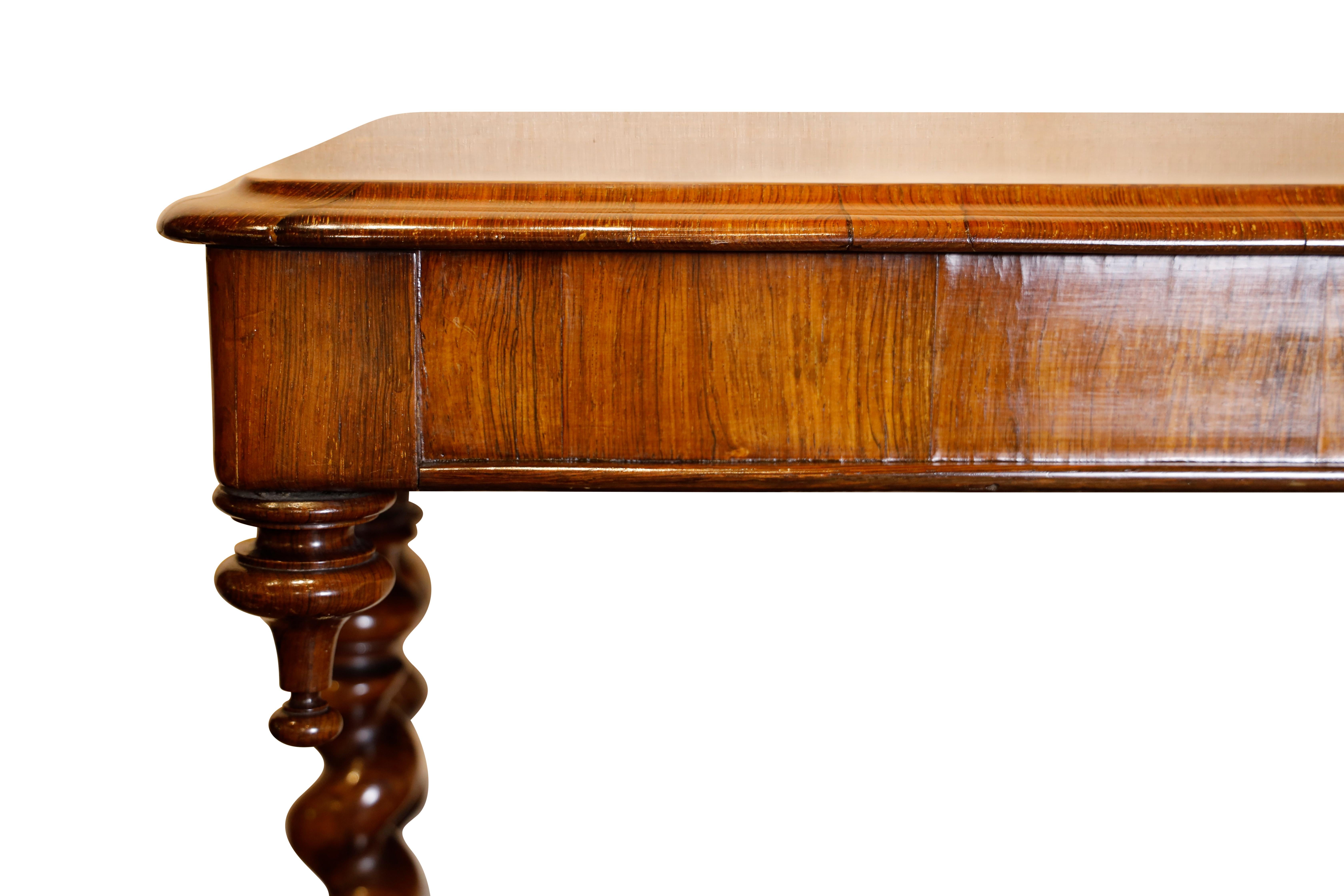 Regency rosewood library table with turned finials.  Barley twist supports with platform and brass castors, connected by barley twist and turned stretchers.