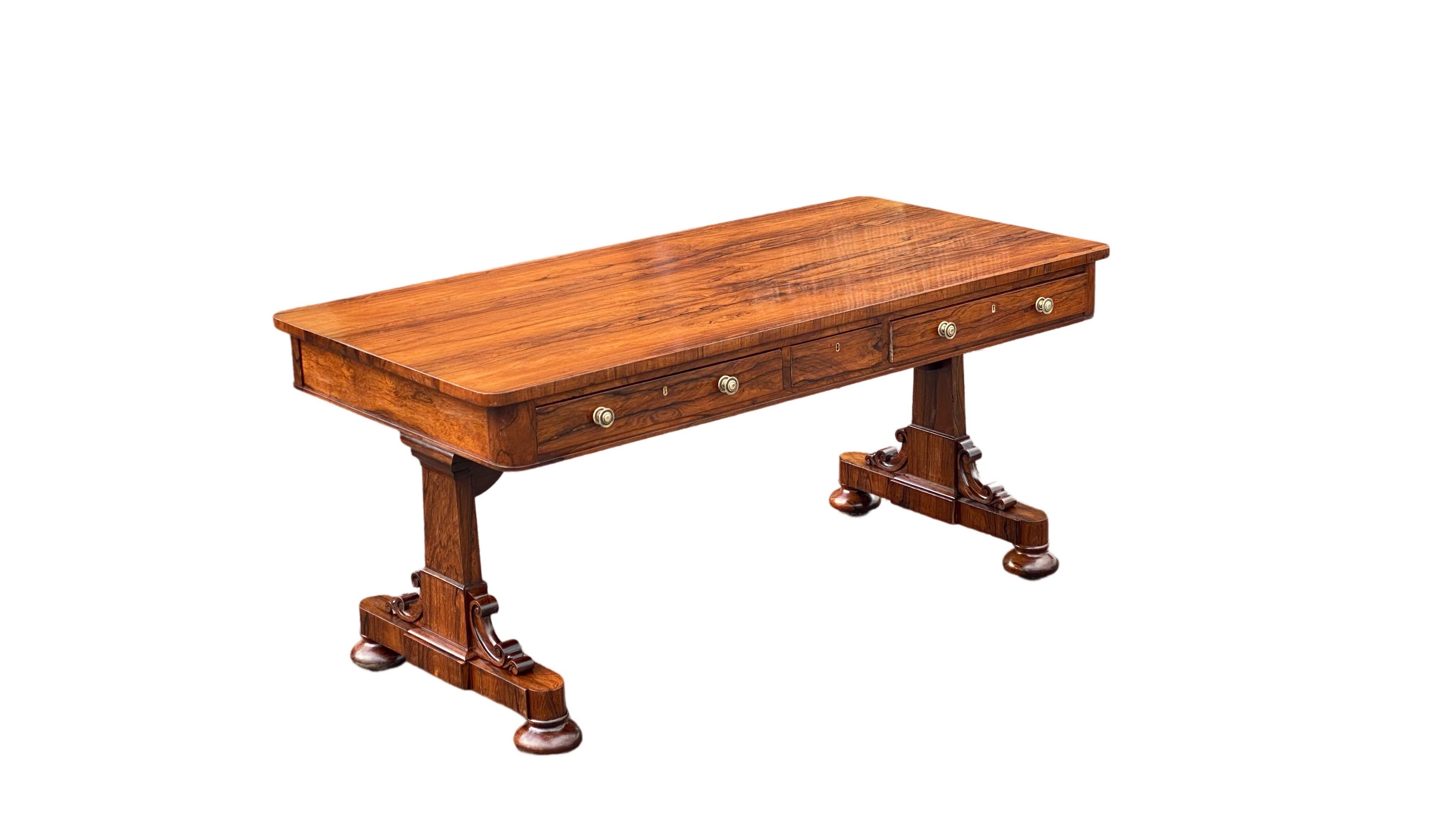 A fine large late Regency rosewood library table. 
The rectangular top with rounded corners containing 2 deep drawers at either end on the front side with a concealed drawer in the centre & dummies to the rear.