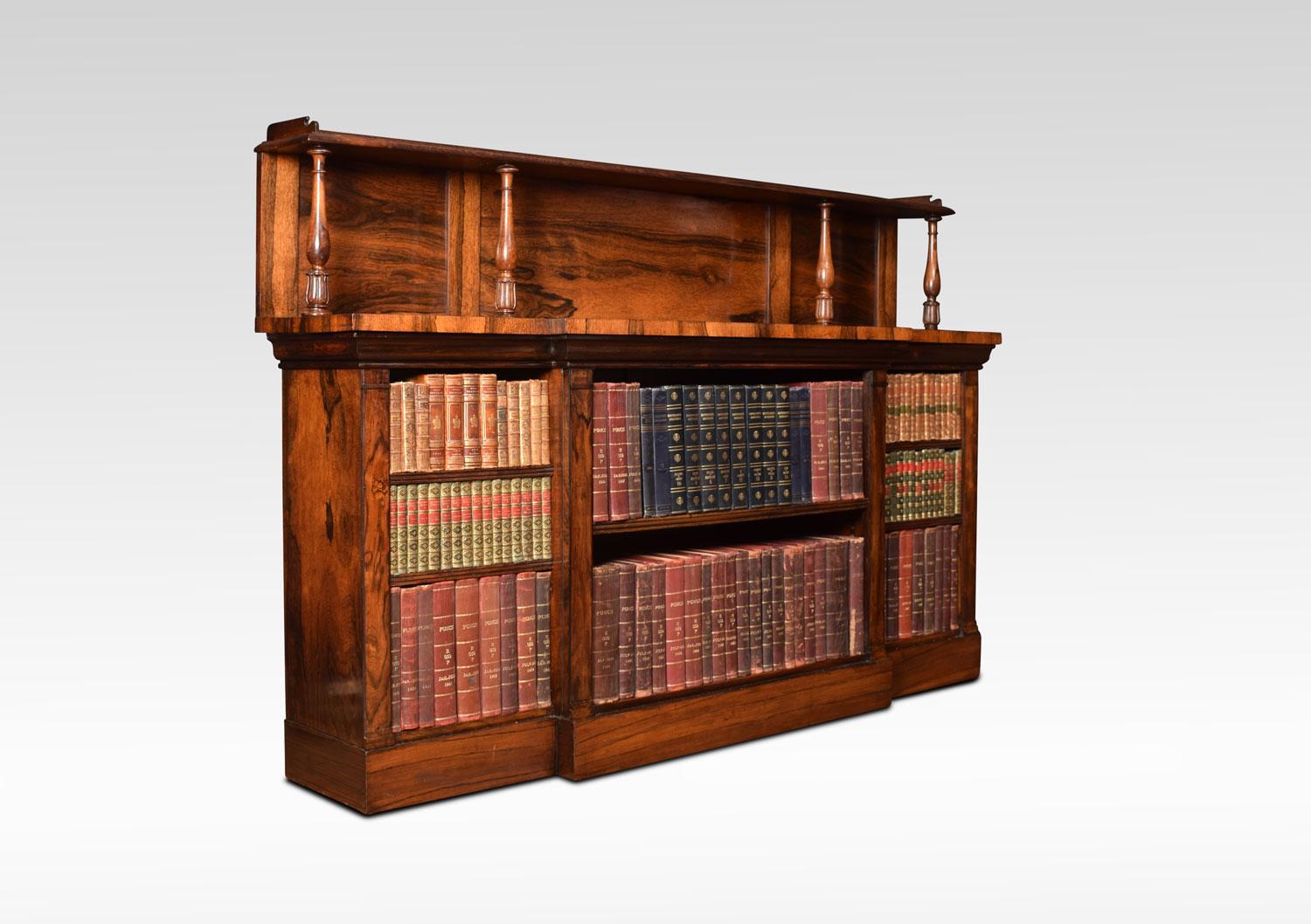 Regency bookcase the raised gallery supported on tulip carved fluted supports, to the large breakfront top with moulded edge. Above three bays of adjustable shelves each section having two shelves. All raised up on plinth base.
Dimensions:
Height