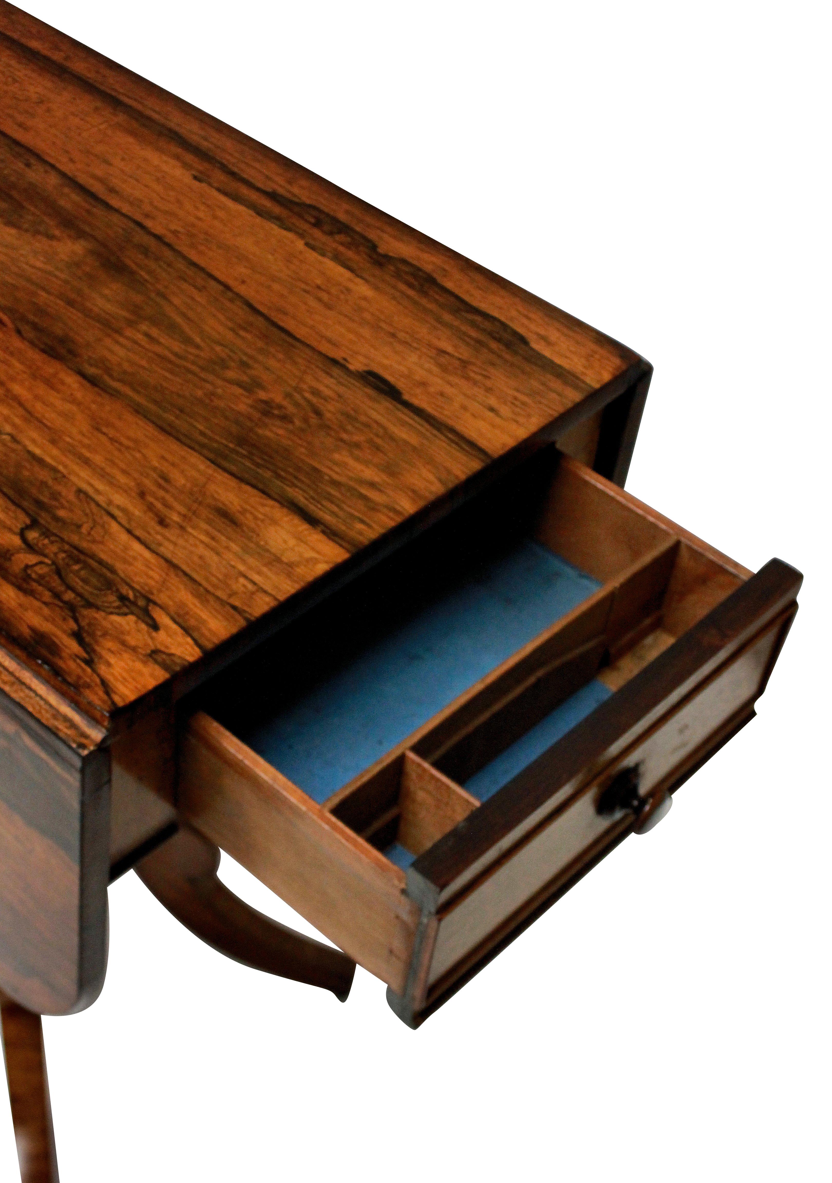 An English Regency period Pembroke table in rosewood. With good figuring throughout, with two side flaps and two drawers.