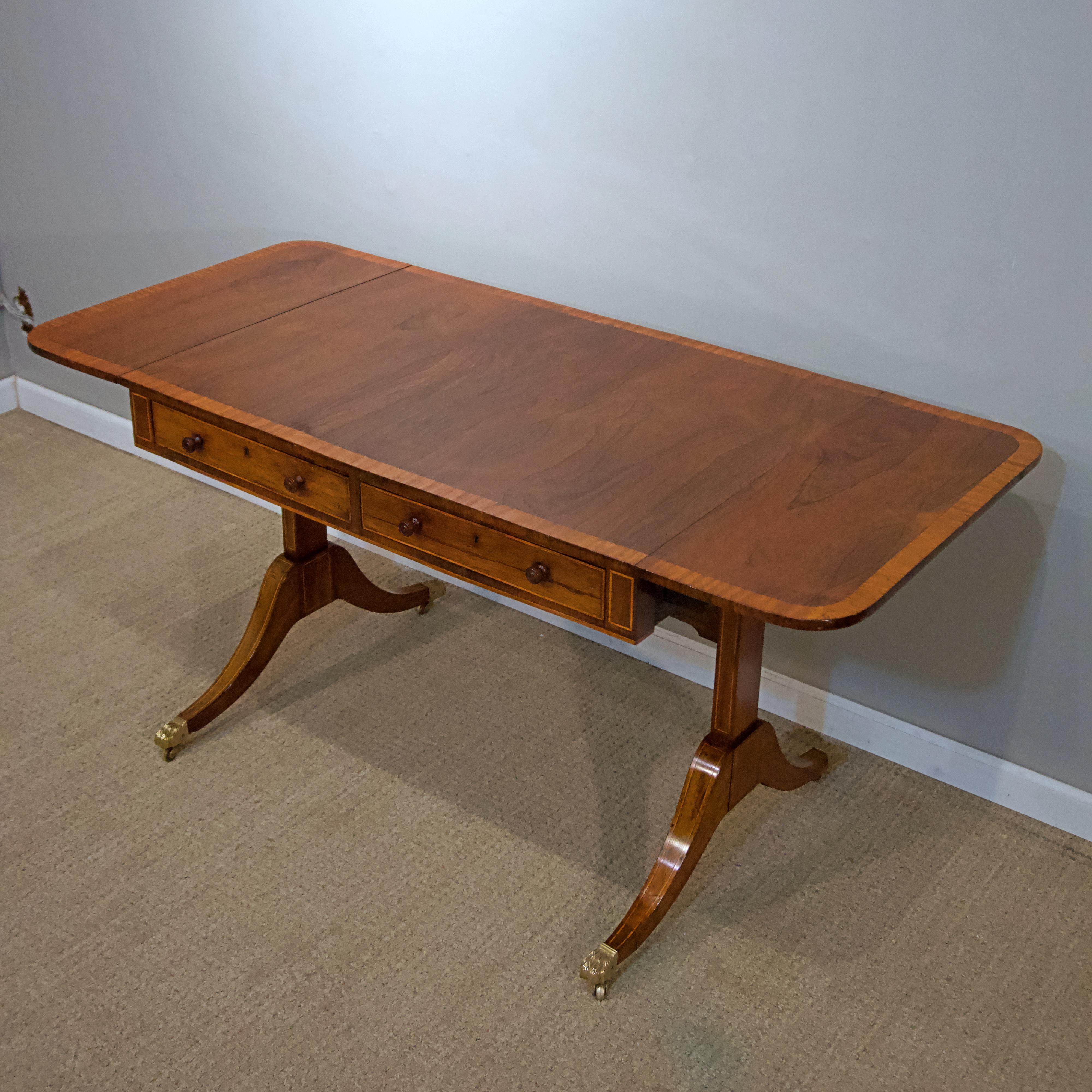 Regency rosewood sofa table

Rosewood veneered over English oak. Warmly patinated color
with wood knobs and brass casters.