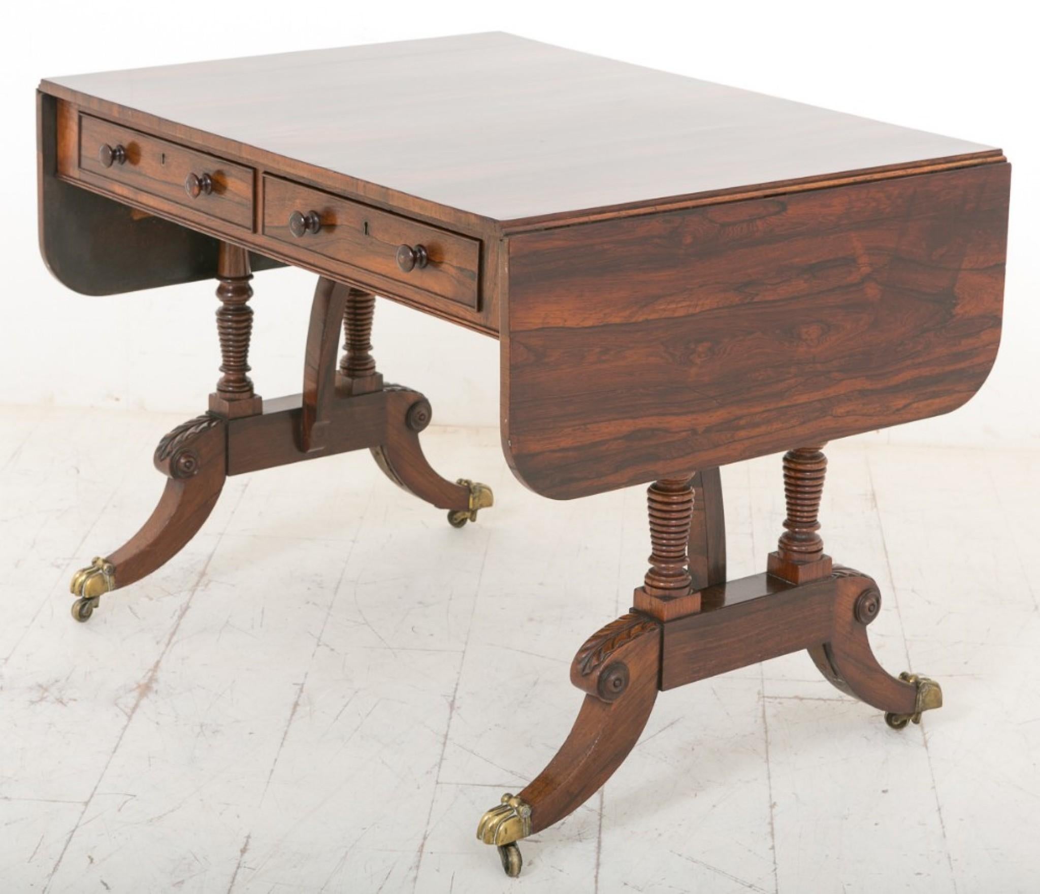A superb Quality Rosewood sofa table.
19th Century
Standing on cast brass castors with a swept leg with carved knees and ring turned supports.
This piece features 2 x Mahogany lined working drawers with 2 x faux drawers to the reverse.
The top