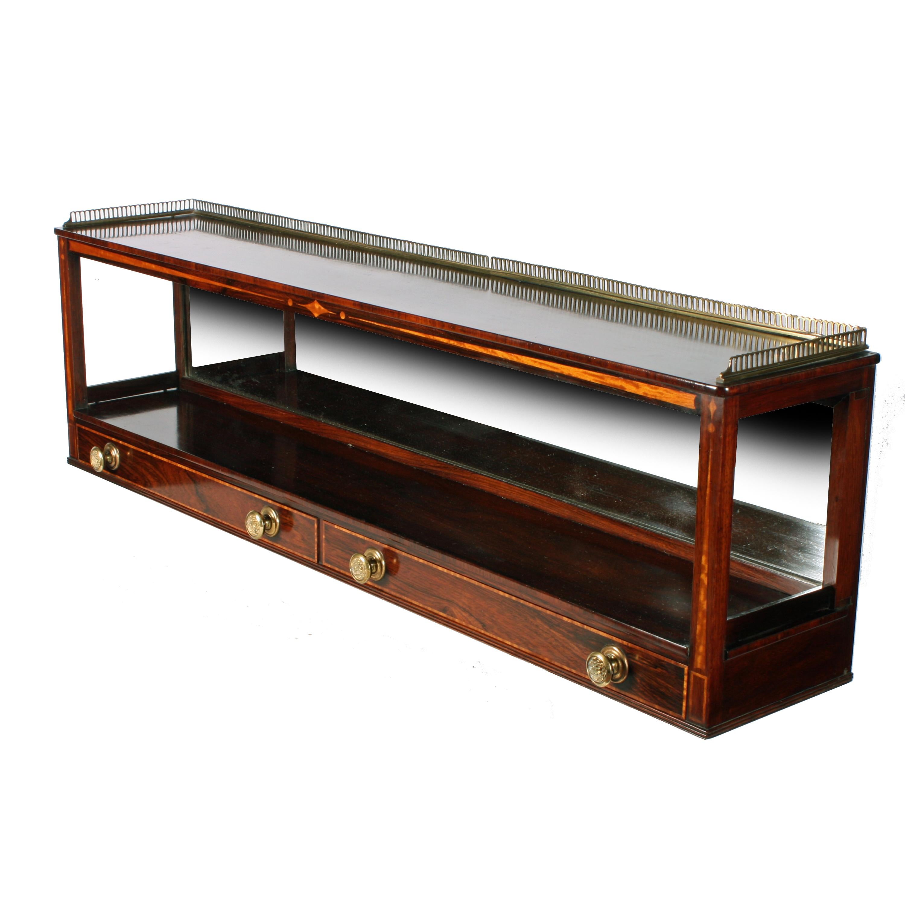 Regency rosewood wall shelf


A fine quality early 19th century Regency rosewood mirror backed wall shelf.

This is an exceptionally made shelf with quality rosewood, rosewood veneers and panels of satinwood inlaid into the square front pillars
