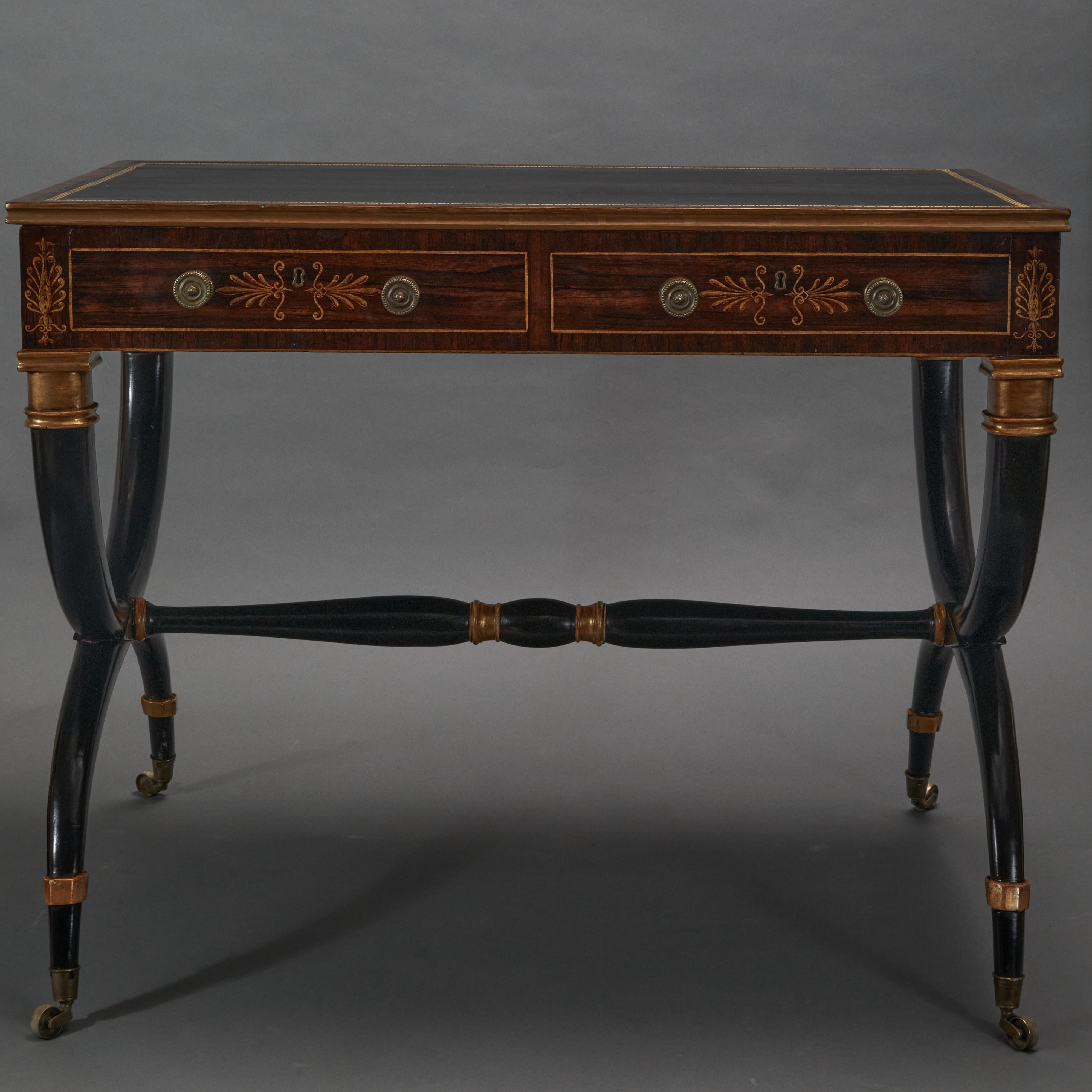 Ebonized and Parcel-Gilt with black leather top and gilded greek key design trim.  2 drawers on front and 2 false drawers on backside.  With original castors and hardware.    