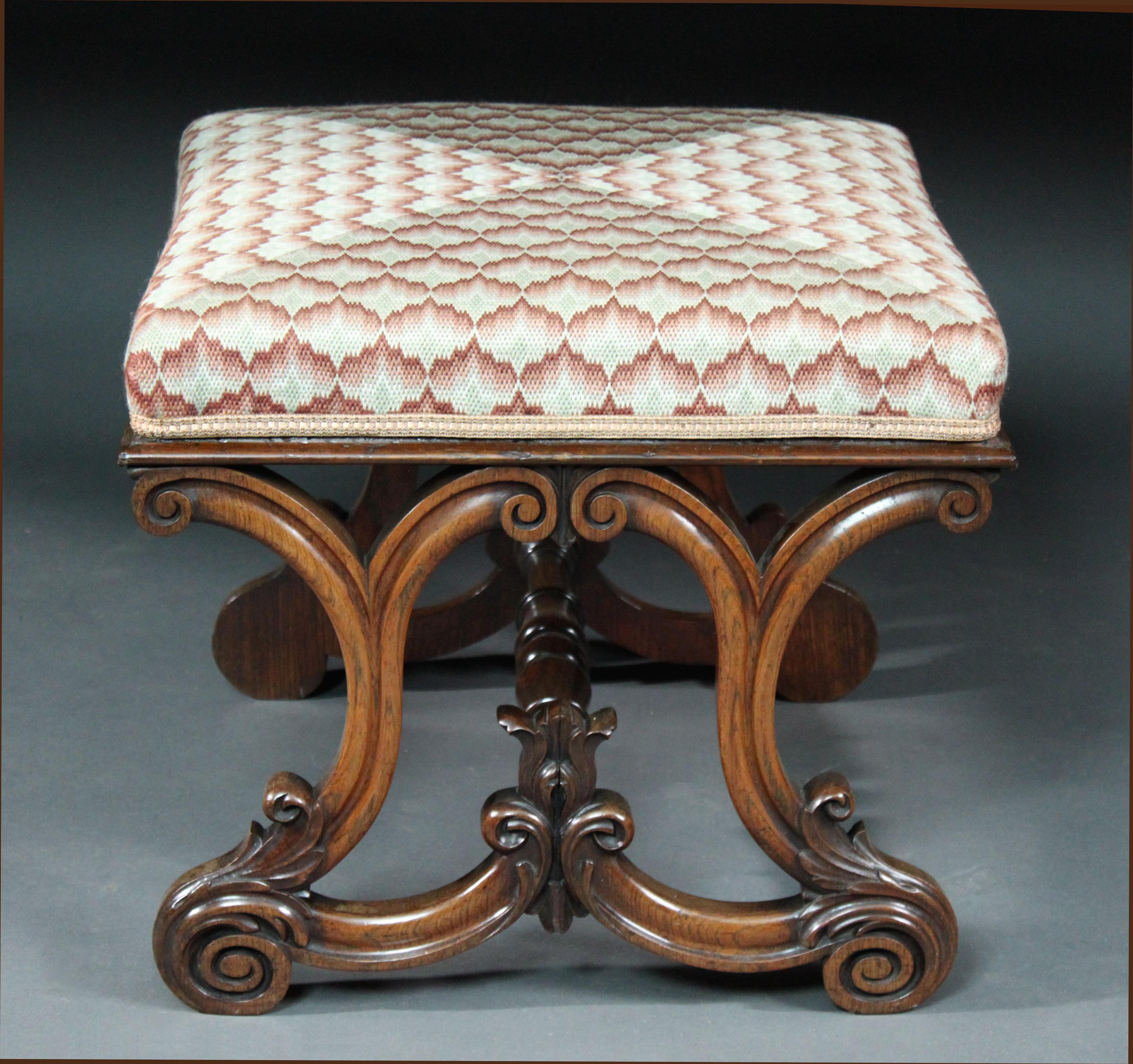 An exceptional late Regency rosewood stool: handome finely carved scrolled ends, larger size than most and well turned stretcher; specially made modern needlework cover.