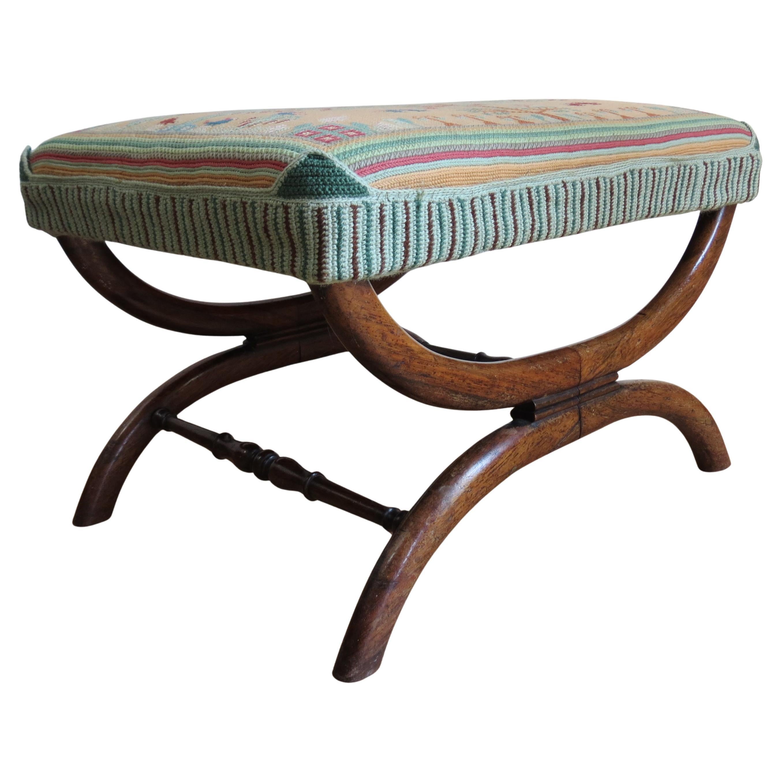 Wonderful footstool made from solid rosewood, dates from the late Regency period, 1830s.  A good quality wide stool with very nicely shaped X frame base and tapestry upholstered seat, the tapestry is not the original but shows some age.  Very well