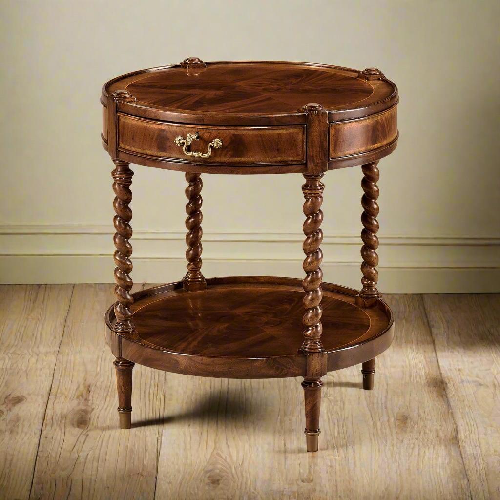 Masterfully crafted from crotch mahogany veneer. The table features elegant crossbanding, enhancing its timeless beauty. 


Supported by barley twist-turned legs, it exudes a sense of refined craftsmanship. The addition of a lower shelf offers