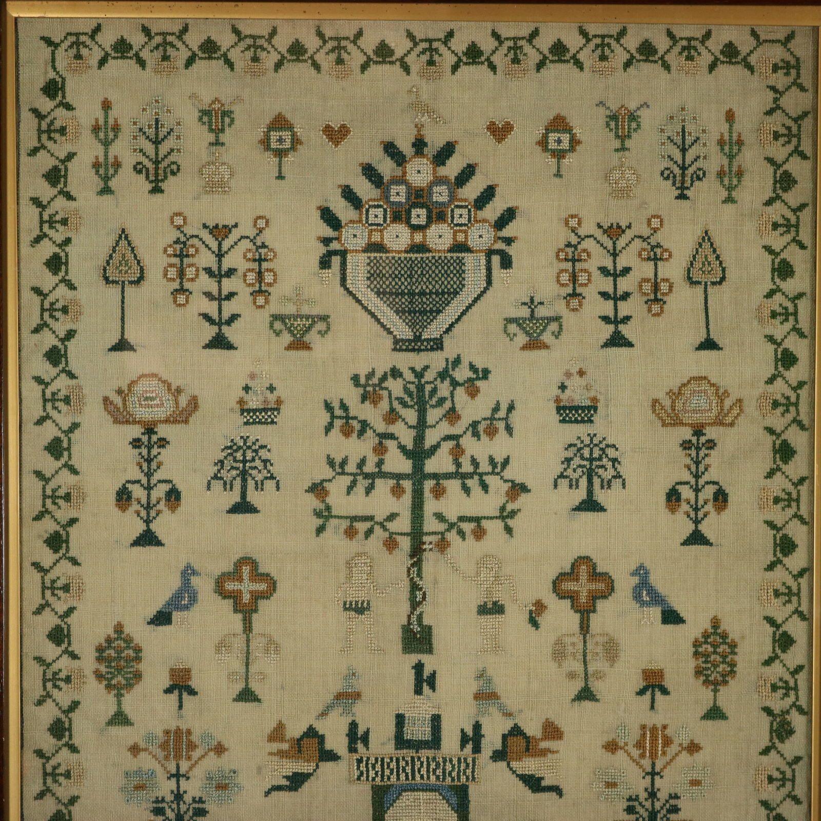 Regency period Sampler, stitched in 1825, by Mary Parry. The sampler is worked in silk threads on a linen ground, mainly in cross stitch. Meandering floral border. Colours green, cream, silver, blue and copper. Signed and dated, 'Mary Parry her Work