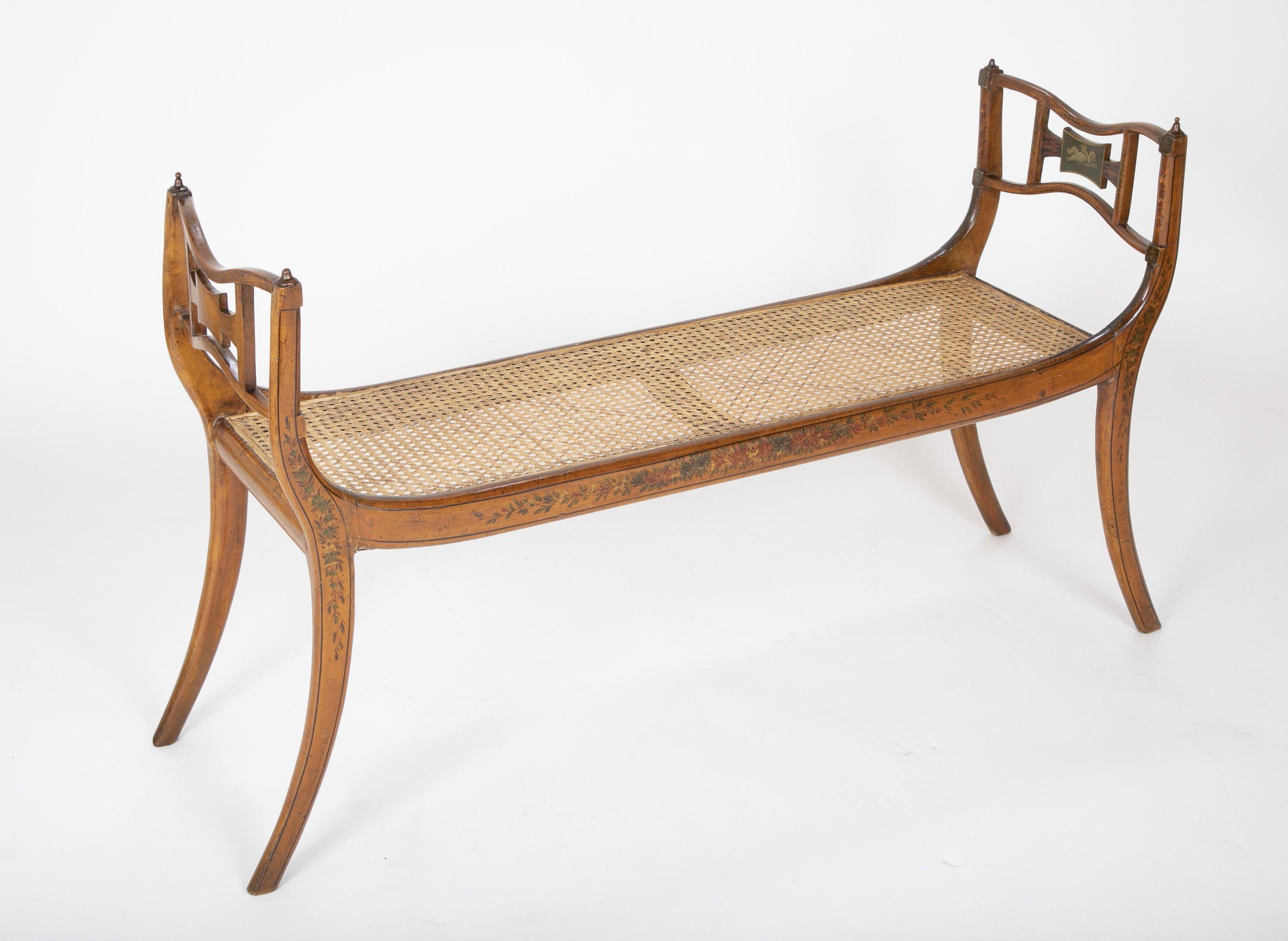 Regency satinwood floral decorated caned seat bench with putti stenciled tablet splats, circa 1810.

Measure: Seat height 16.5