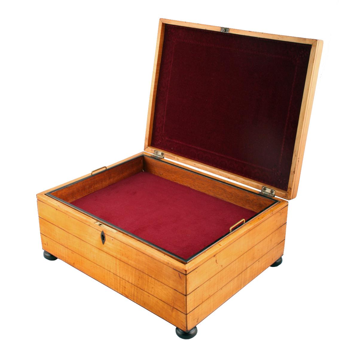 A fine Regency oblong shaped satinwood and inlaid jewel box.

The box stands on ebonised bun feet with a working lock and key and a lift out tray.

The box is veneered and inlaid with a wide variety of woods, the front, back and sides with long