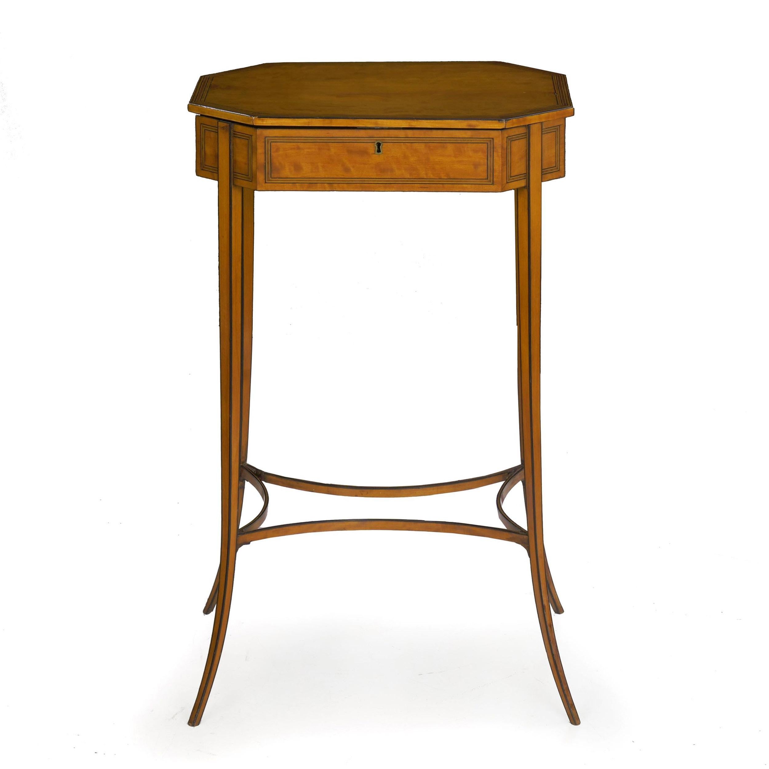 An exquisite form of very fine craftsmanship, this gorgeous accent table has an octagonal body with a lid lifting on original hinges to access a tidy fitted interior. A fine piece of golden satinwood is framed with multiple borders of stringer