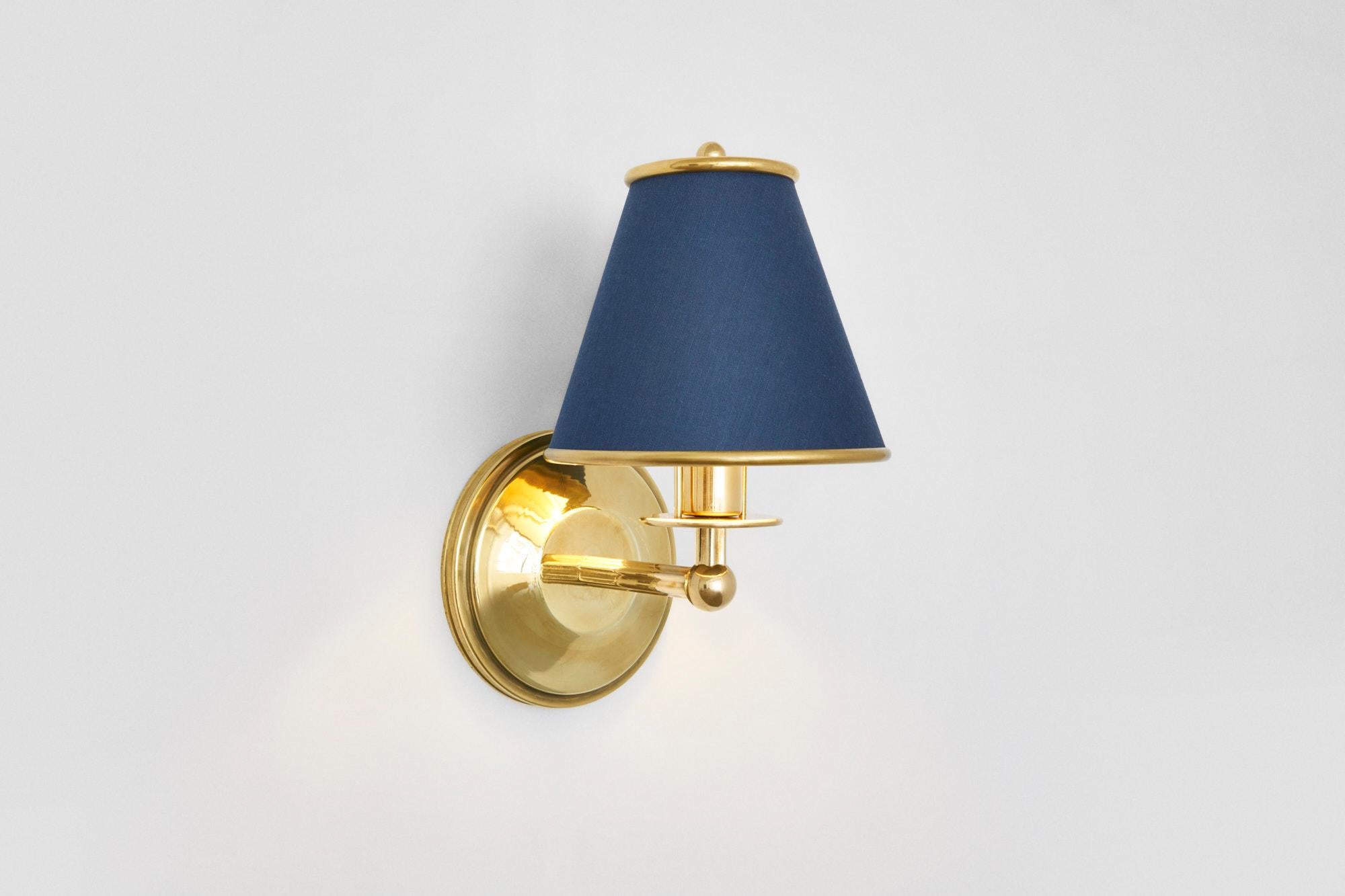 Materials
Metal: Brushed brass, blackened brass, antique brass, bronze, brushed nickel
Shade: navy, burgundy, or COM

Measurements: 5.75 W x 7 D x 9.75 H inches
Illumination
LED E-12 candelabra bulb

Notes:
Custom options : finish
Price
