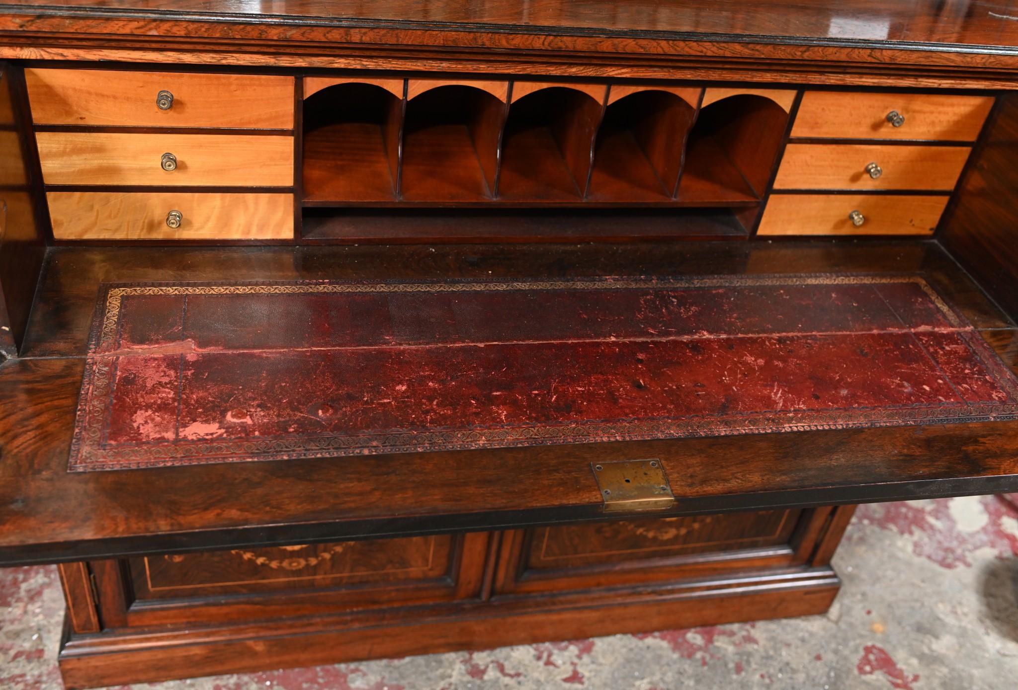 Stunning Regency Revival secretaire bookcase in mahogany
Grand piece of furniture with middle section opening out to reveal desk area 
Features a red tooled leather writing surface and various cubby holes and drawers
Inlay work is incredible