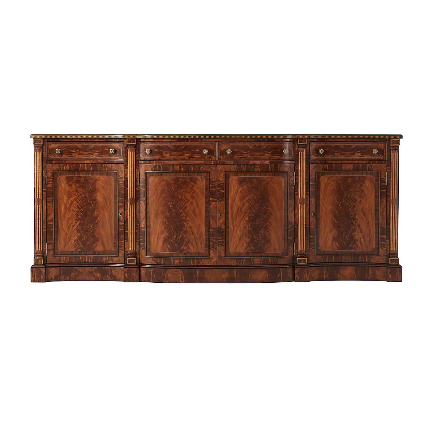 A fine Regency Serpentine credenza with flame mahogany and Morado banding, with Fine double stringing in sycamore and ebony, the serpentine crossbanded top above four frieze drawers, above four paneled cabinet and lockable cabinet doors flanked by