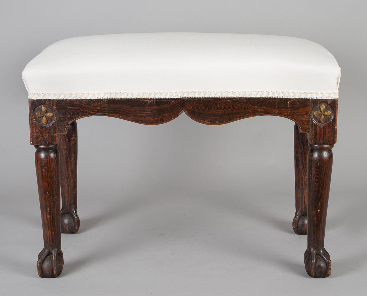 Regency simulated rosewood bench with shaped apron, gilded Gothic quatrefoil carving on the leg block above turned legs ending in ball and claw feet.