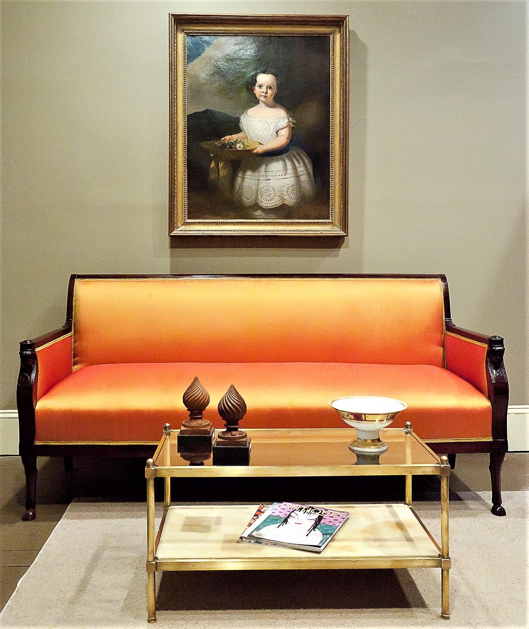 Classical sofa with mahogany frame with hand-carved Greek caryatids at the ends of the arms and hoofed animal feet. Old French polish. Covered in iridescent silk.